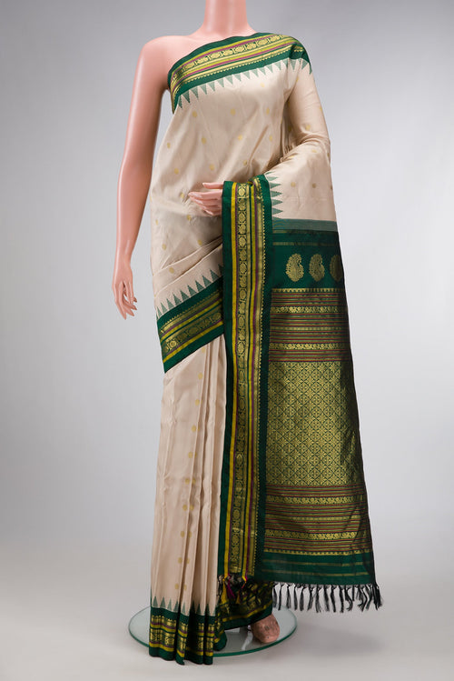 Beige Dual Tone Gadwal Silk Saree with Zari Butta on the body and Temple Border.  displayed on a mannequin