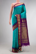 Maya Blue Dual Tone Gadwal Silk Saree with Zari Butta on the body and Zari Border.  displayed on a mannequin