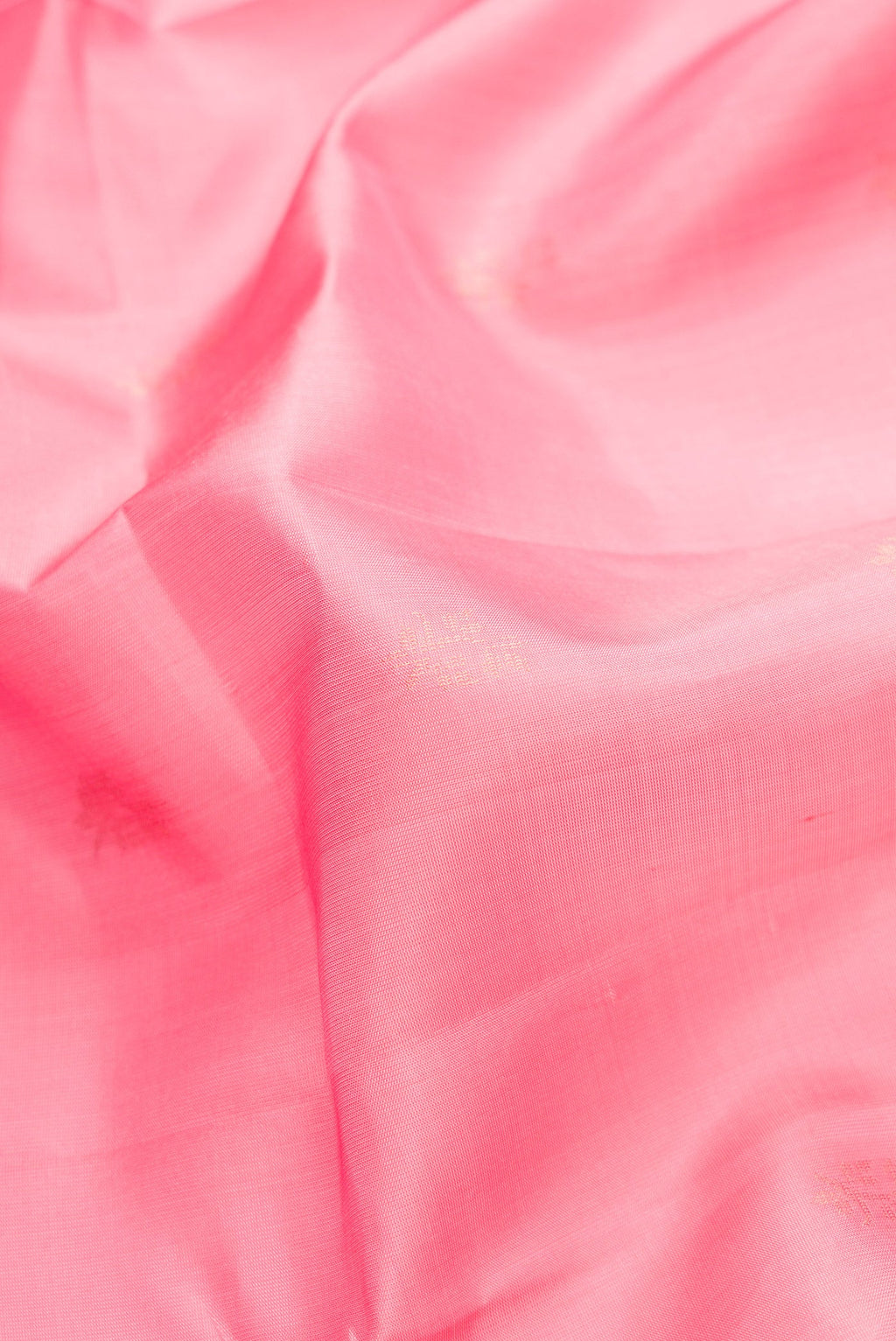 Close up of Pink Dual Tone Soft Silk Saree with Zari Butta on the body and Zari Border.  displaying folds