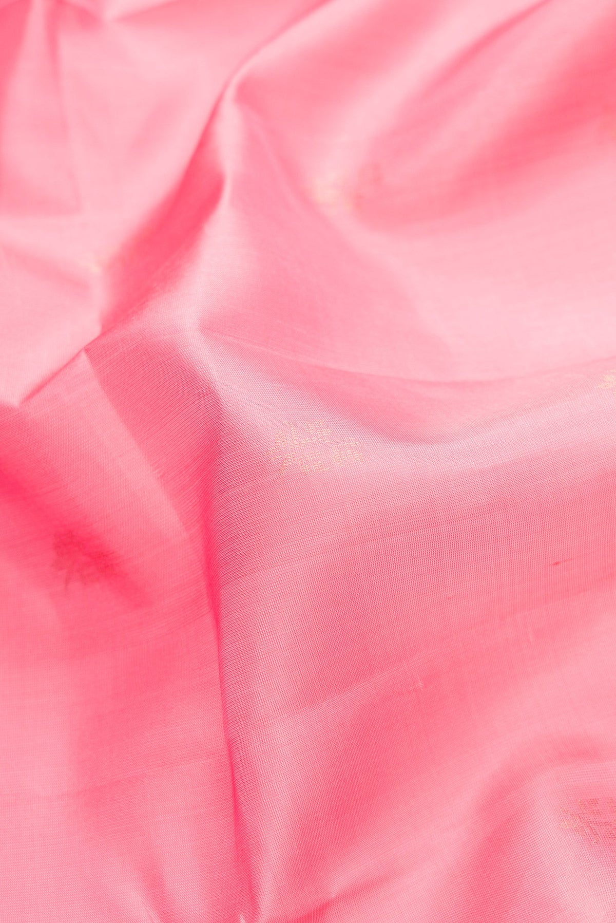 Close up of Pink Dual Tone Soft Silk Saree with Zari Butta on the body and Zari Border.  displaying folds