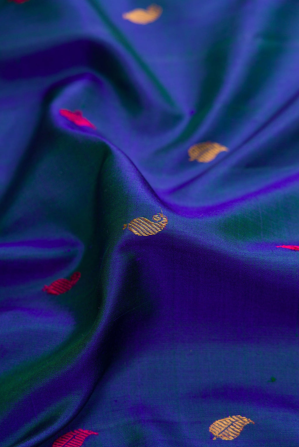 Close up of Peacock Blue Dual Tone Gadwal Silk Saree with Zari And Thread Butta on the body and Zari Border.  displaying folds