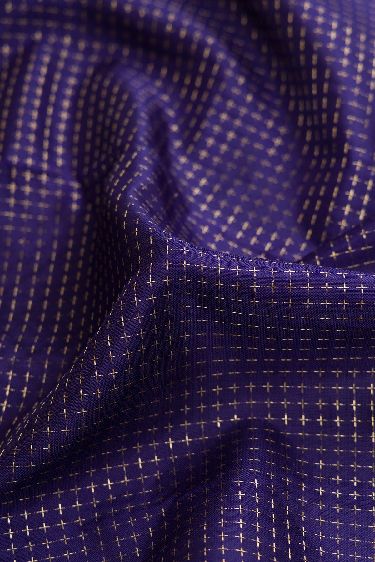 Close up of Navy Blue Dual Tone Kanjivaram Silk Saree with Checked design on the body and Zari Border.  displaying folds