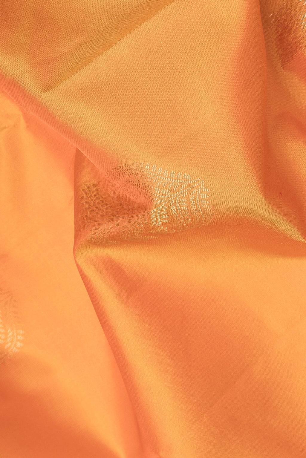 Close up of Orange Dual Tone Soft Silk Saree with Zari Butta on the body and Zari Border.  displaying folds