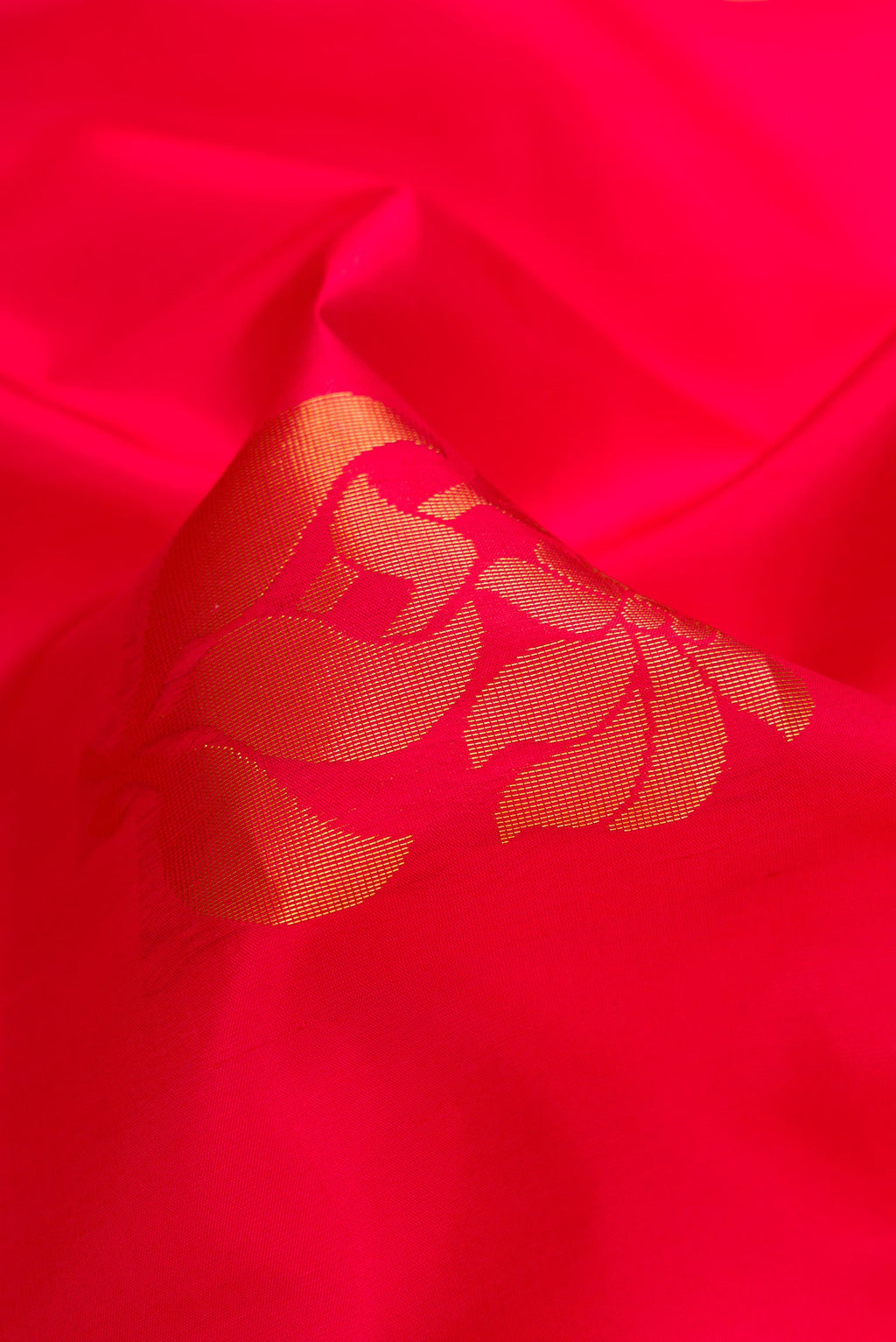 Close up of Red Dual Tone Soft Silk Saree with Zari Butta on the body and Zari Border.  displaying folds