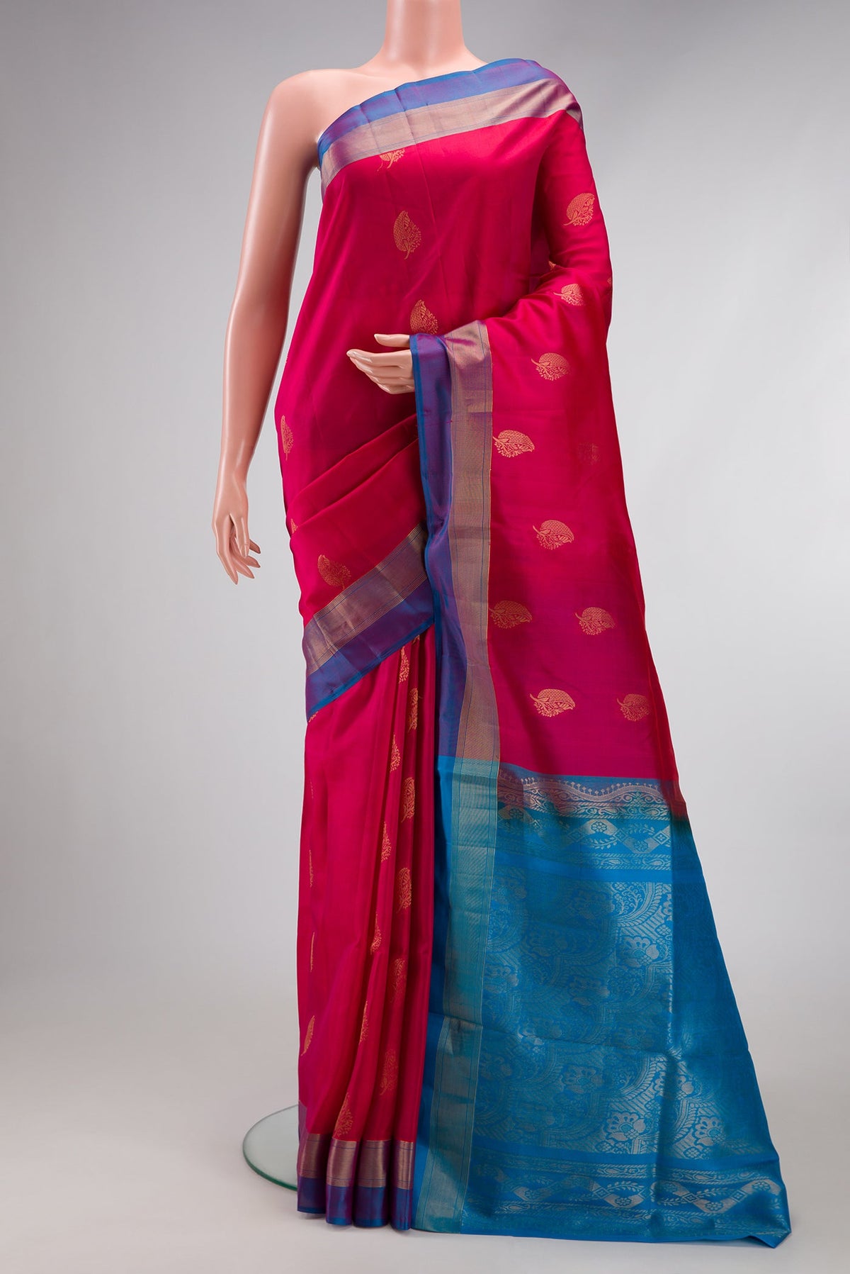 Dark Pink Soft Silk Saree with Zari Butta on the body and Fancy Border.  displayed on a mannequin