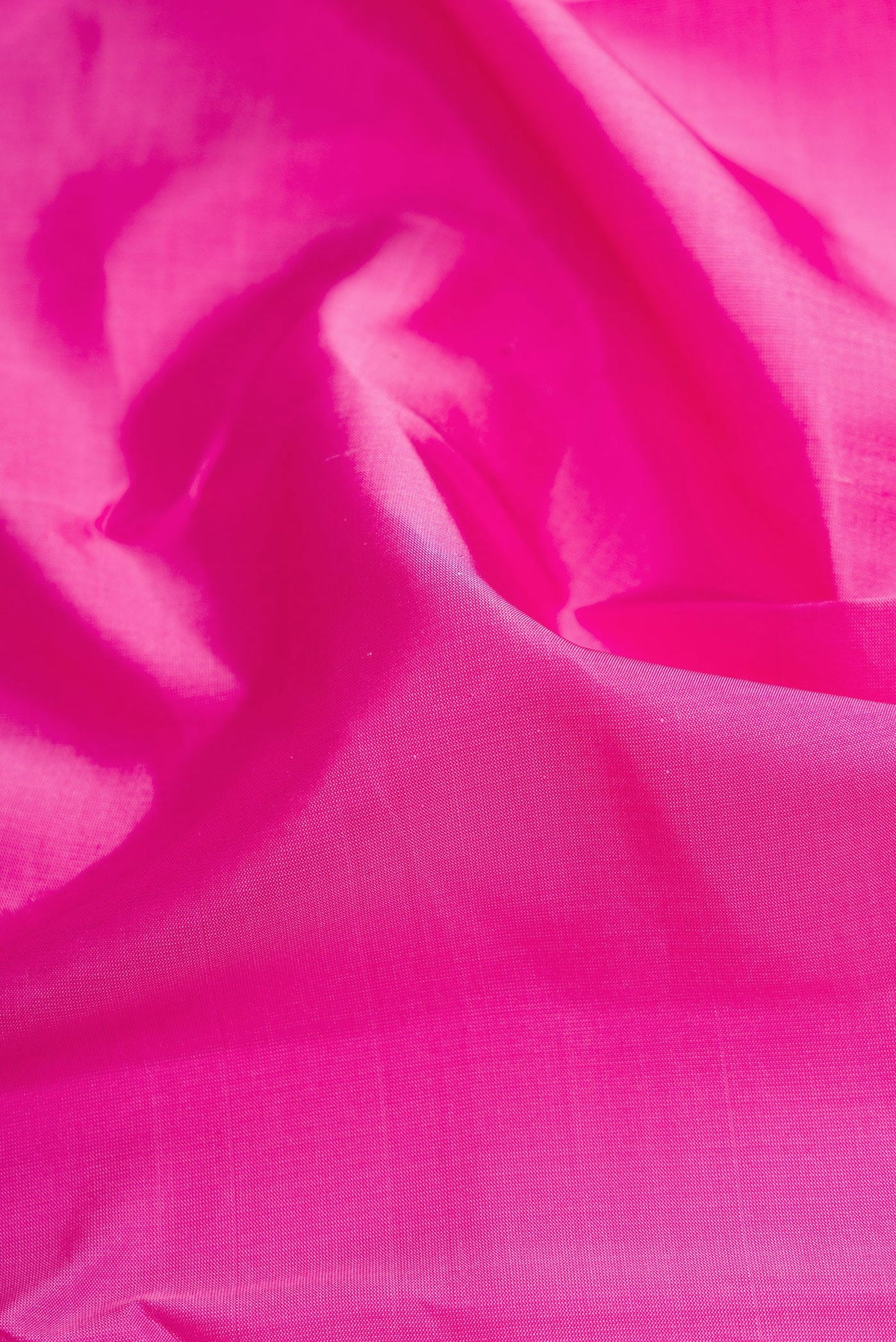 Close up of Pink Dual Tone Kanchipuram Silk Saree with Plain Body and Zari Border.  displaying folds