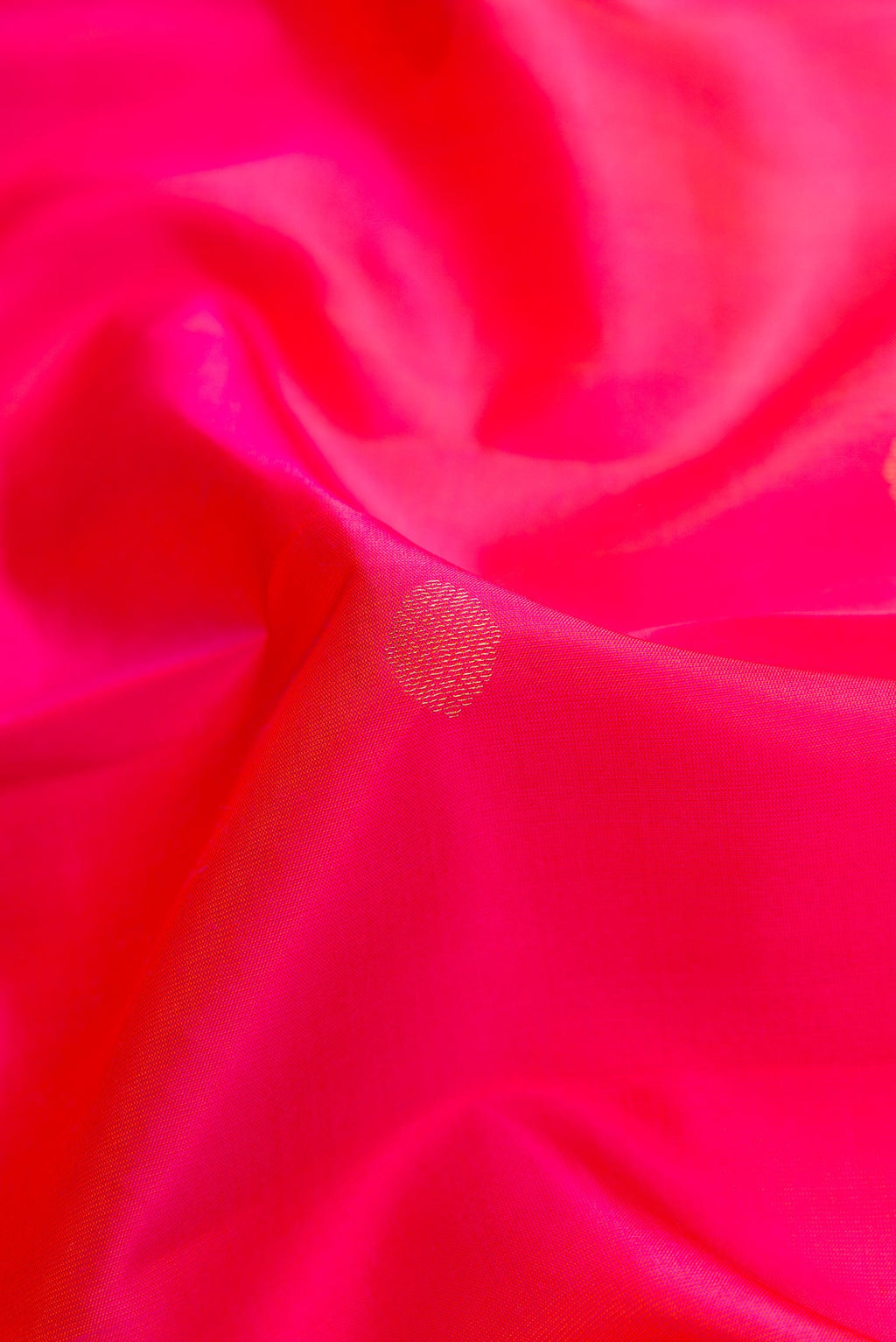 Close up of Pink Dual Tone Kanchipuram Silk Saree with Zari Butta on the body and Zari Border.  displaying folds