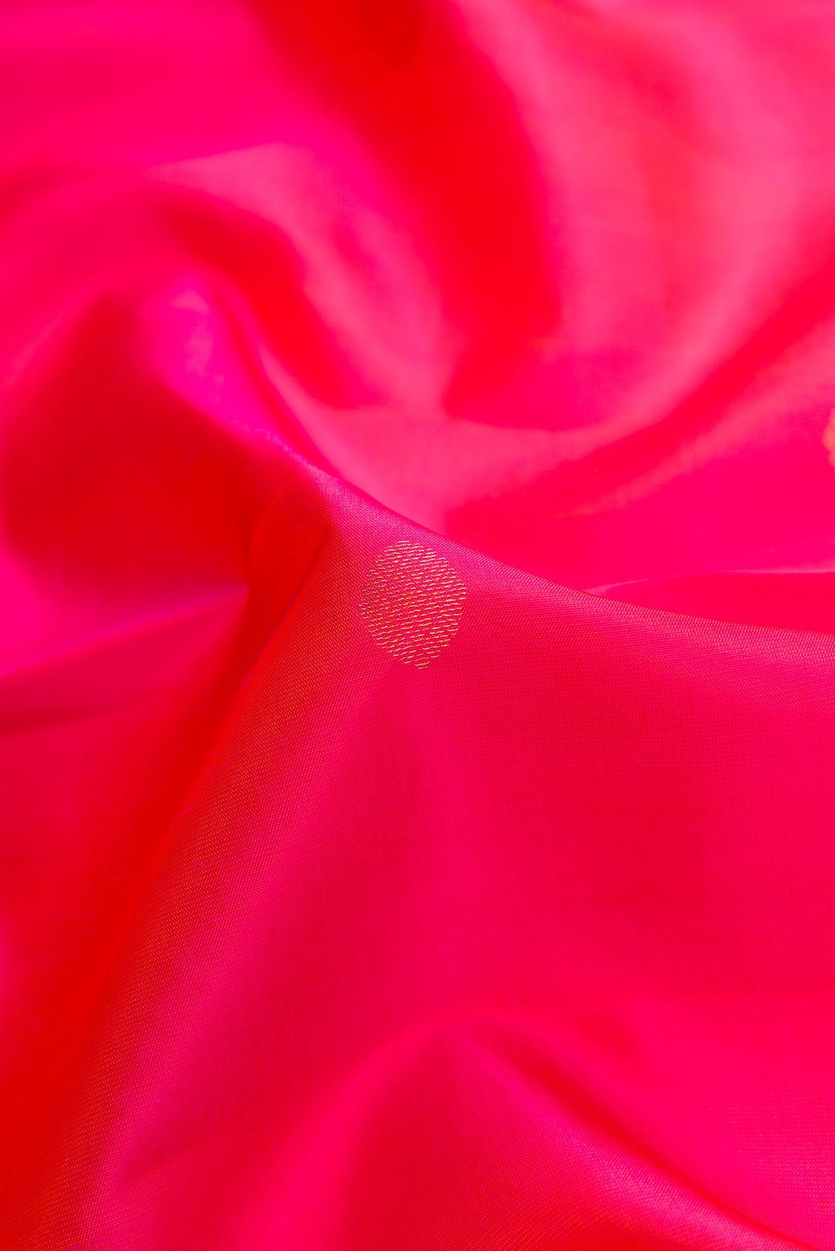 Close up of Pink Dual Tone Kanchipuram Silk Saree with Zari Butta on the body and Zari Border.  displaying folds