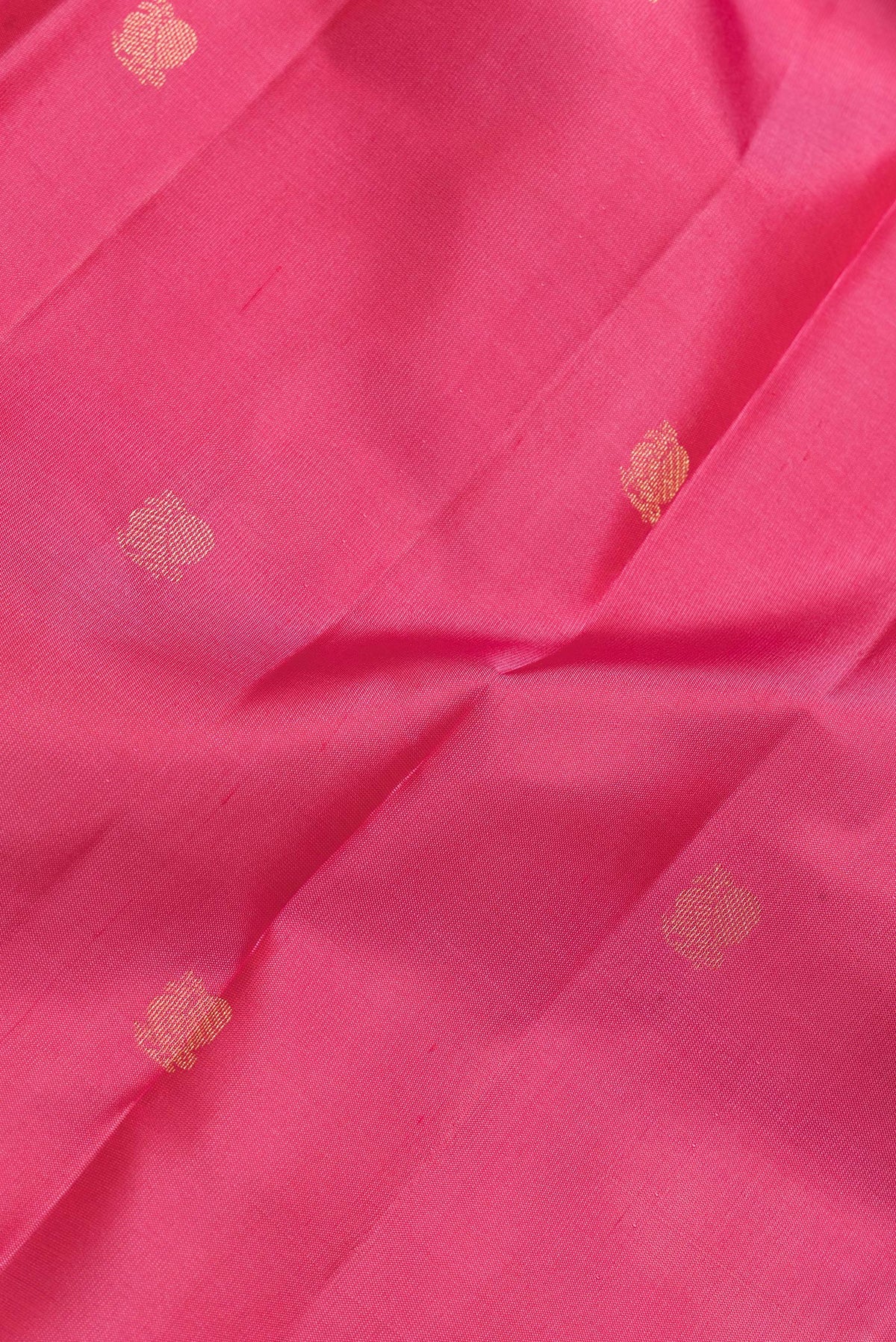 Close up of Pink Dual Tone Kanjivaram Silk Saree with Zari Butta on the body and Zari Border.  displaying folds