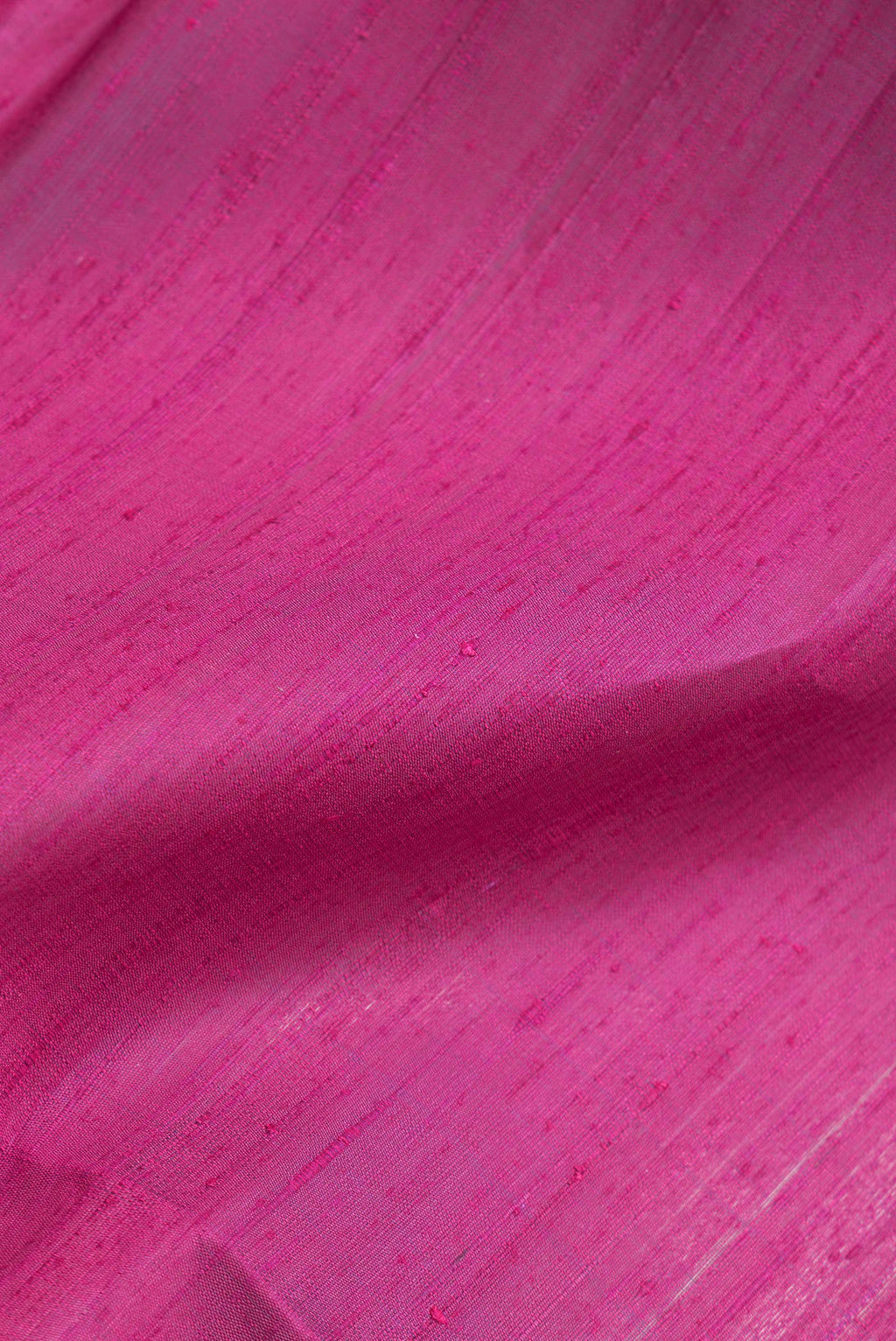 Close up of Dark Pink Dual Tone Banarasi Raw Silk Saree with Plain Body and Zari Border.  displaying folds