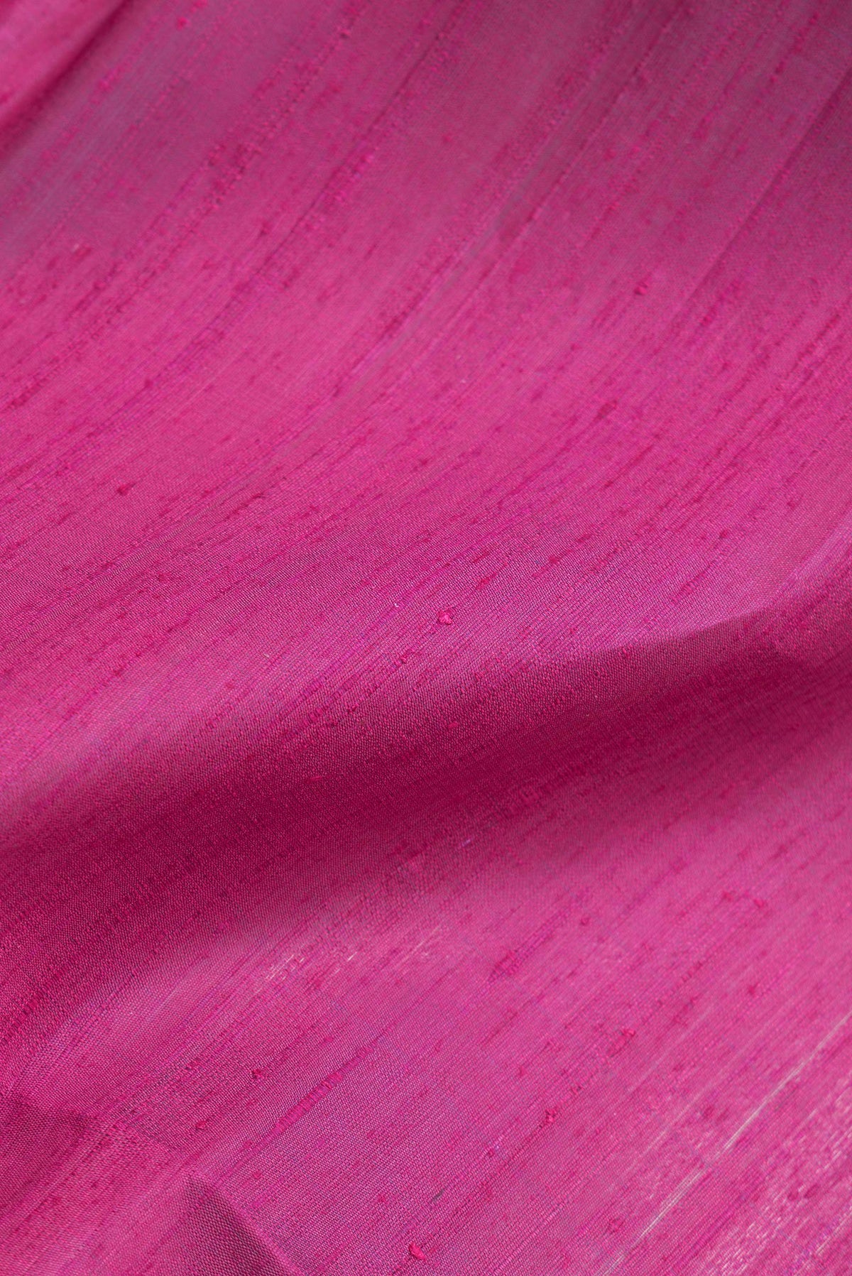 Close up of Dark Pink Dual Tone Banarasi Raw Silk Saree with Plain Body and Zari Border.  displaying folds