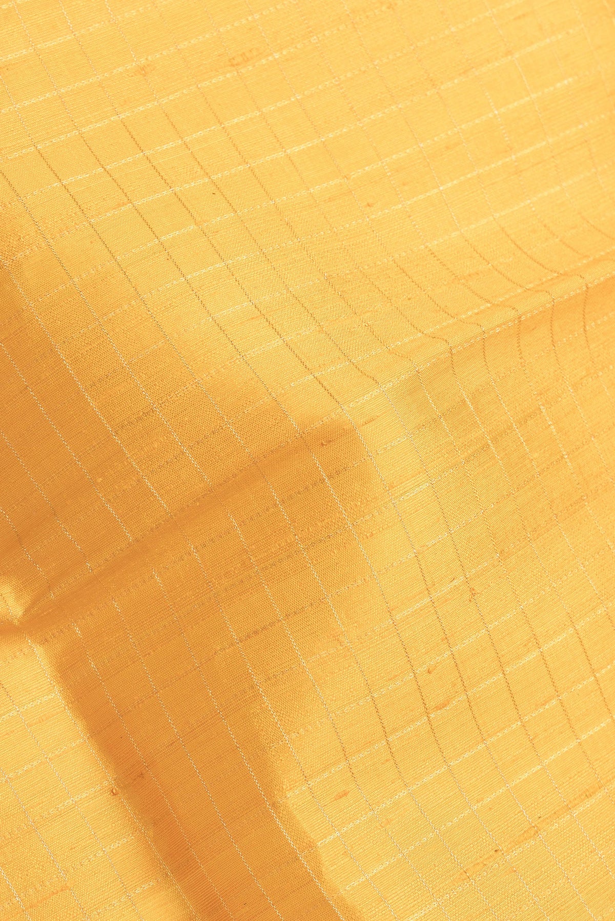 Close up of Yellow Dual Tone Raw Silk Saree with Checked design on the body and Zari Border.  displaying folds