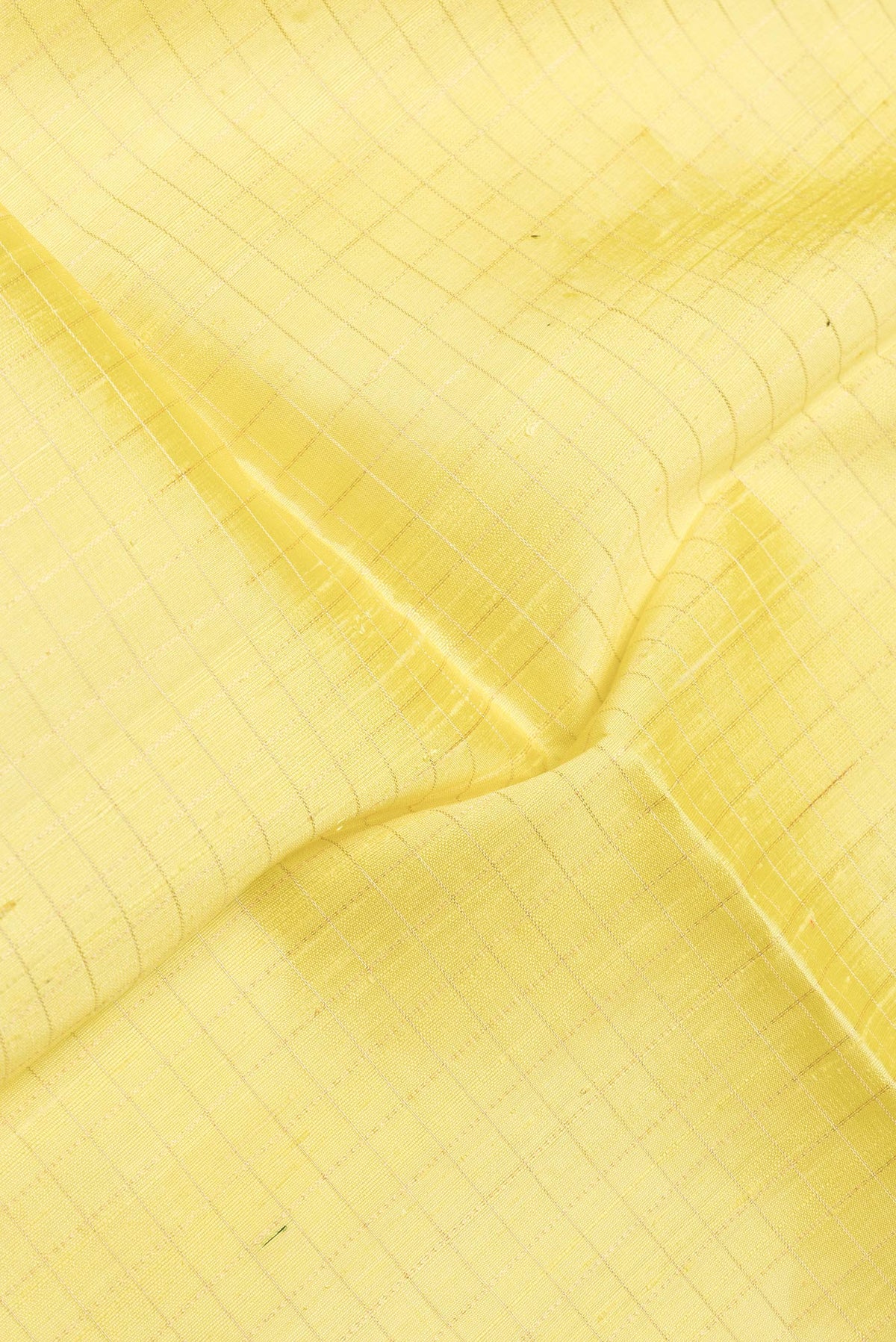 Close up of Yellow Dual Tone Raw Silk Saree with Checked design on the body and Zari Border.  displaying folds