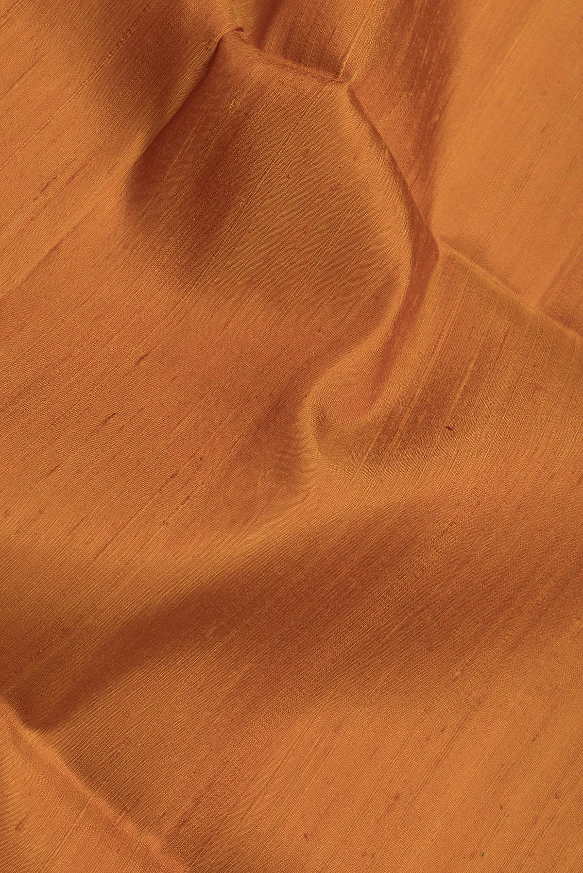 Close up of Mustard Dual Tone Raw Silk Saree with Plain Body and Fancy Border.  displaying folds