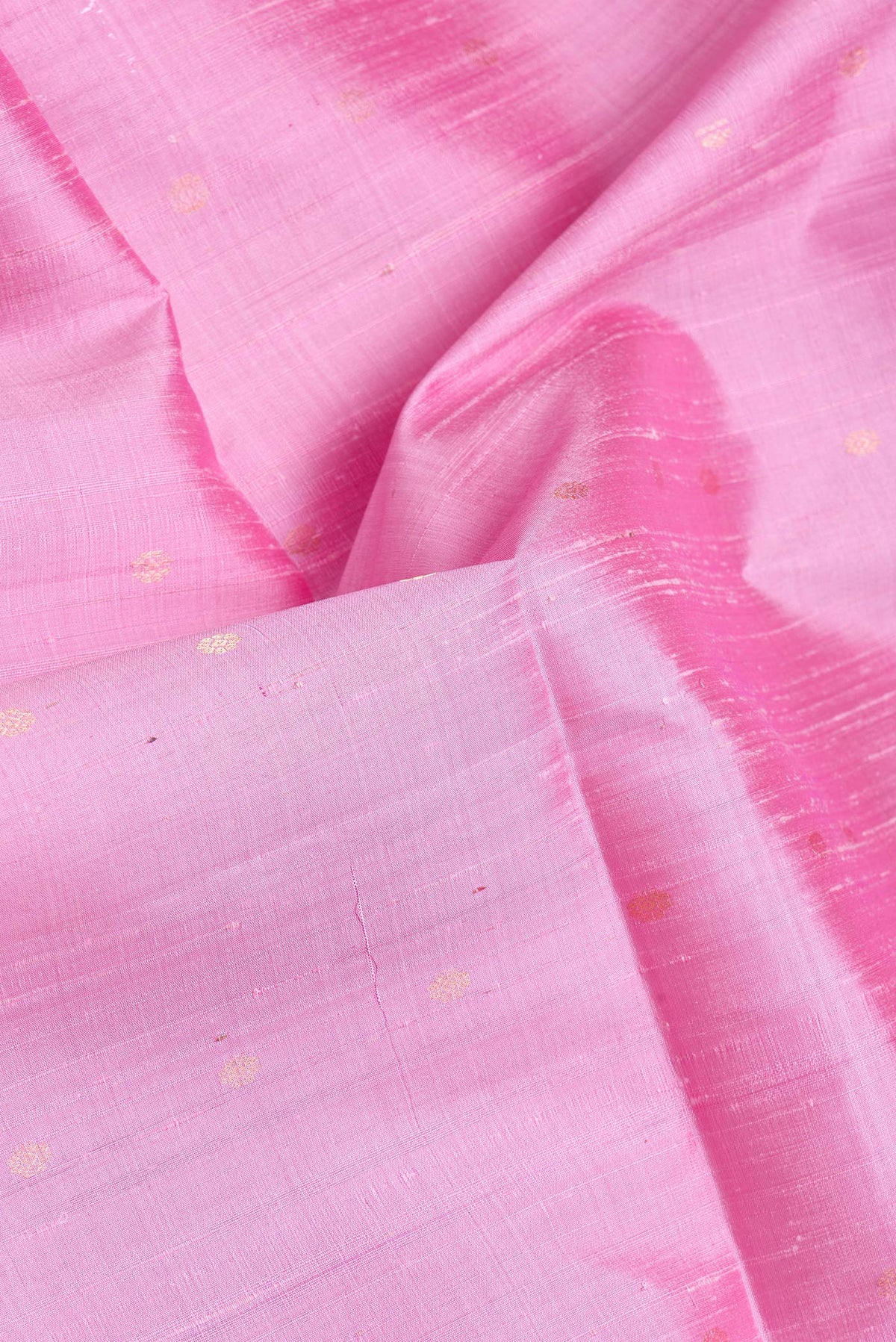 Close up of Pink Dual Tone Raw Silk Saree with Zari Butta on the body and Zari Border.  displaying folds