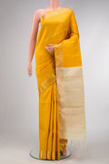 Mustard Dual Tone Raw Silk Saree with Zari Butta on the body and Zari Border.  displayed on a mannequin