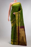 Mehandi Green Dual Tone Kanjivaram Silk Saree with Zari Butta on the body and Zari Border.  displayed on a mannequin