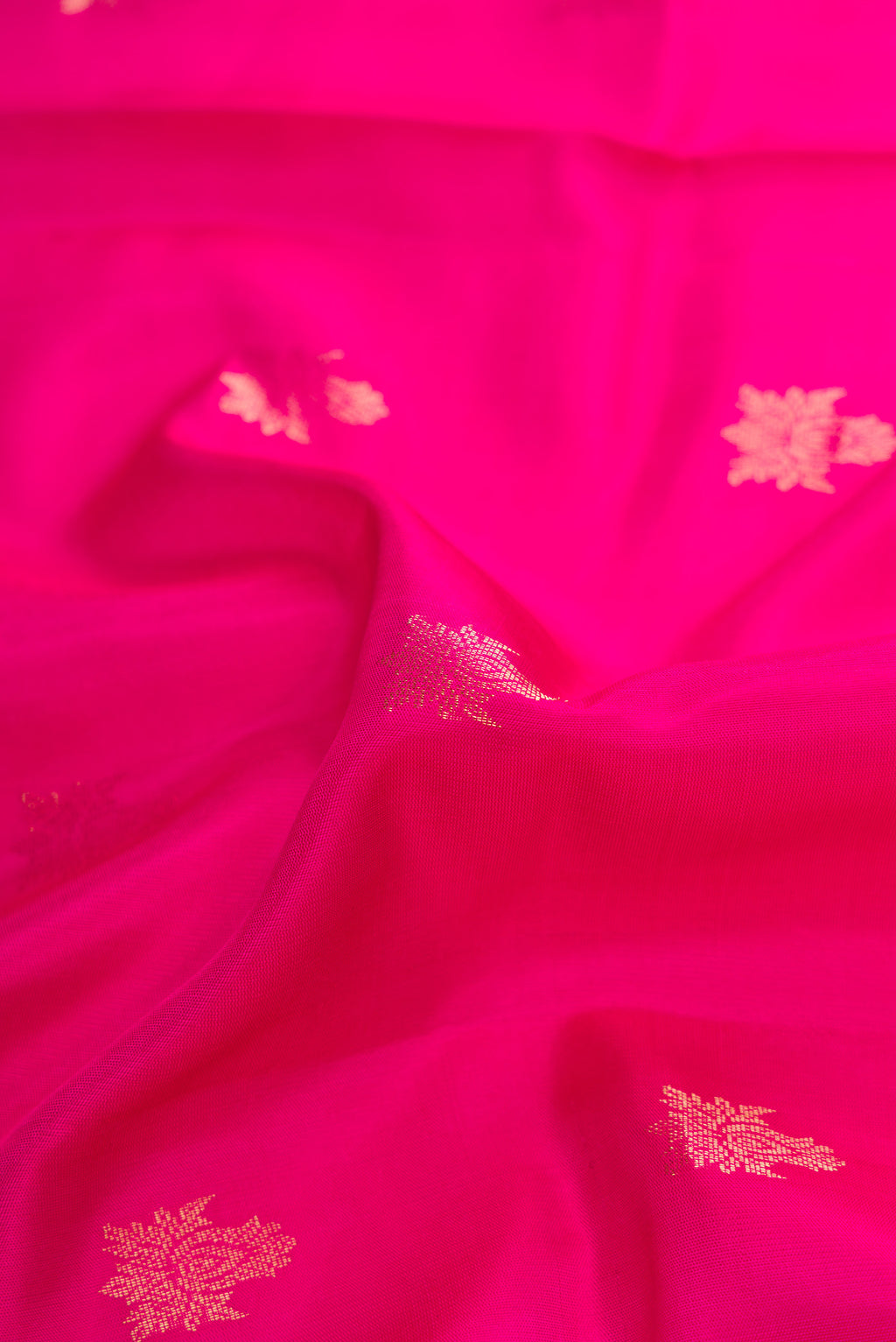 Close up of Pink Soft Silk Saree with Zari Butta on the body and Zari Border.  displaying folds
