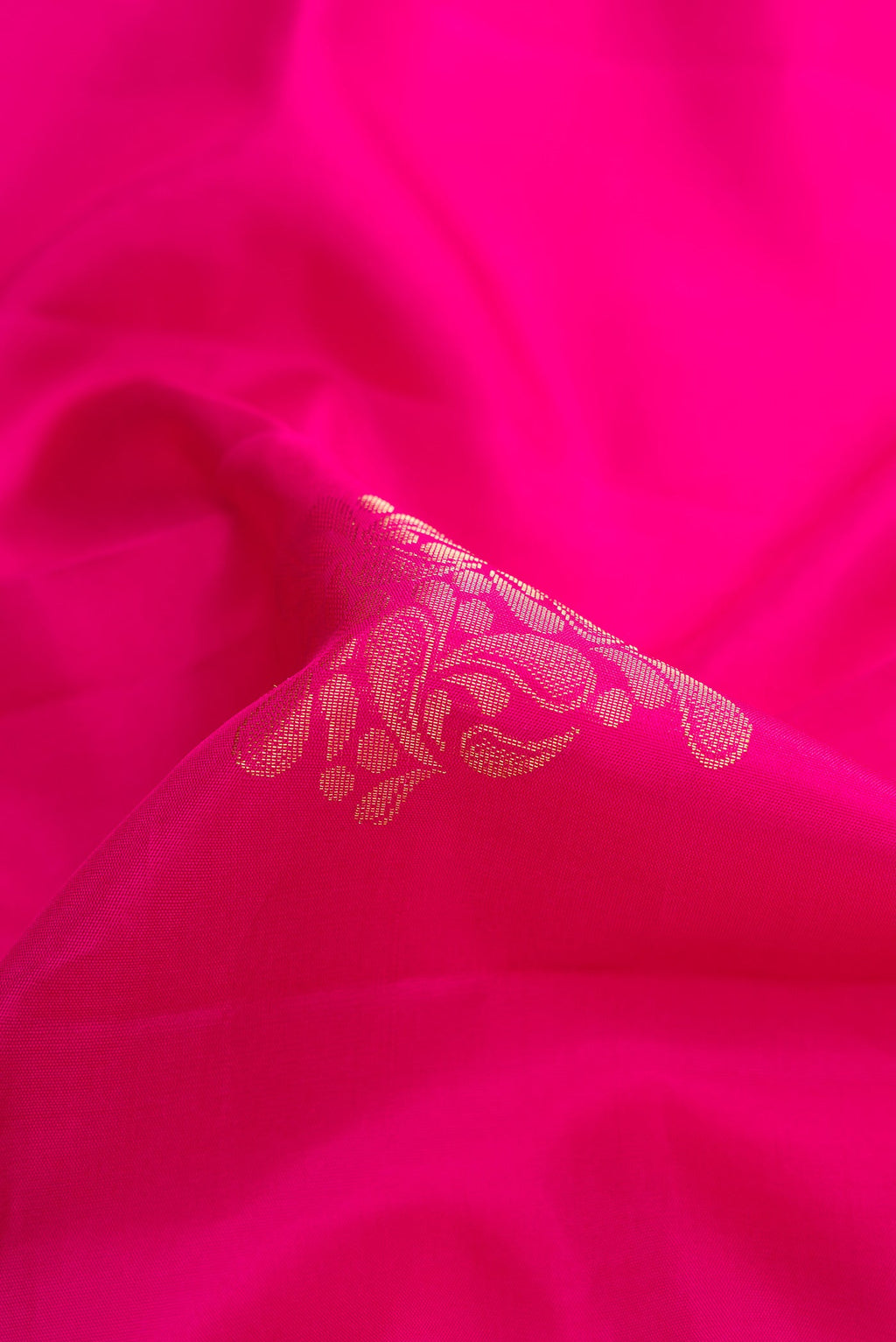 Close up of Pink Dual Tone Soft Silk Saree with Zari Butta on the body and Zari Border.  displaying folds