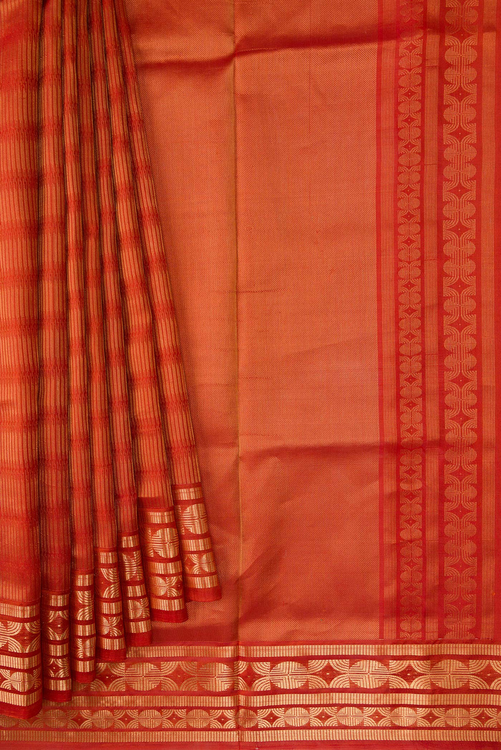Pleats and pallu of Rust Soft Silk Saree with Zari Butta on the body and Zari Border. 