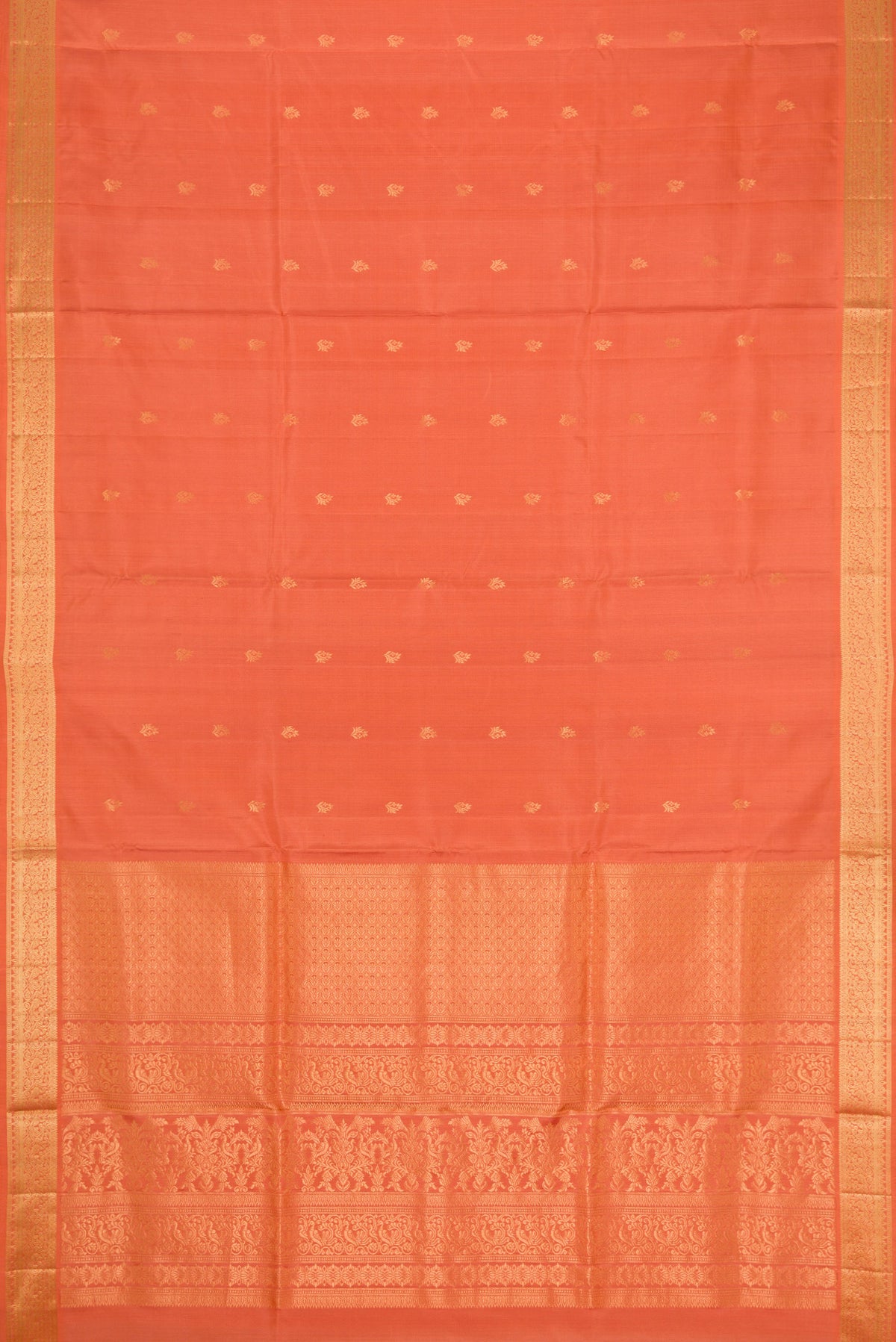 Flat view of Peach Soft Silk Saree with Zari Butta on the body and Zari Border. 
