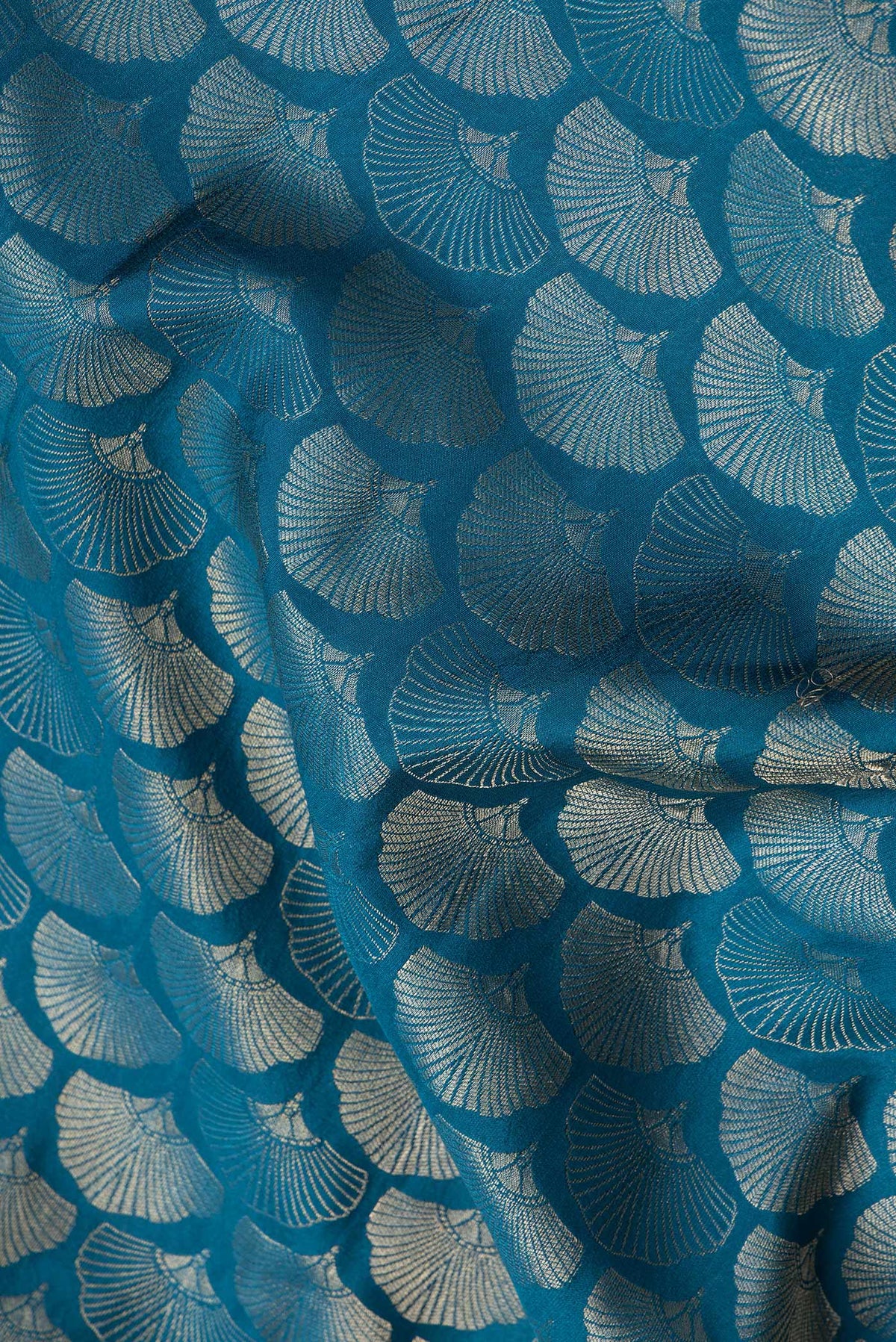 Close up of Peacock Blue Dual Tone Tussar Silk Saree with Zari Brocade on the body and Zari Border.  displaying folds