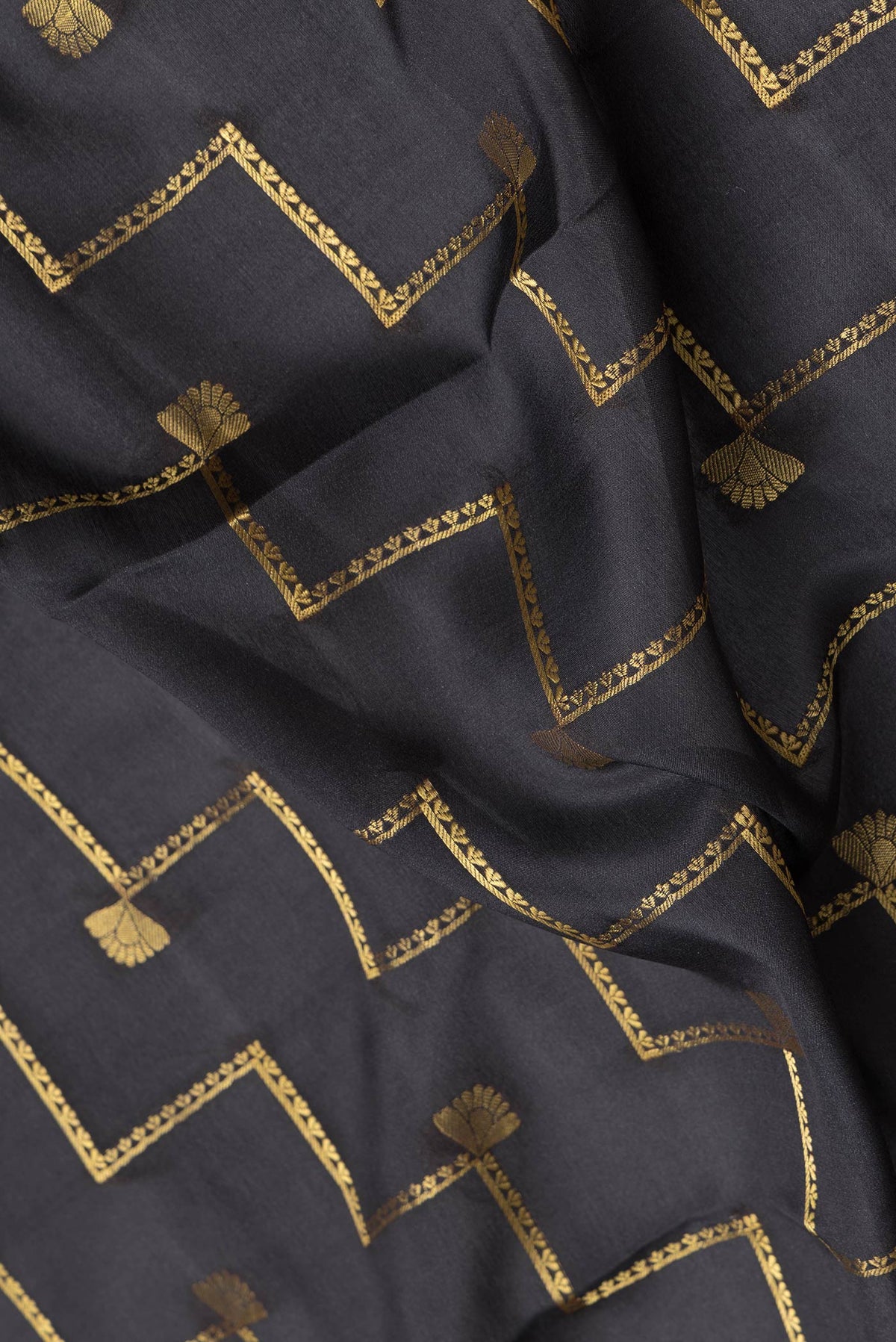 Close up of Black Dual Tone Mysore Silk Saree with Zari Butta on the body and Fancy Border.  displaying folds