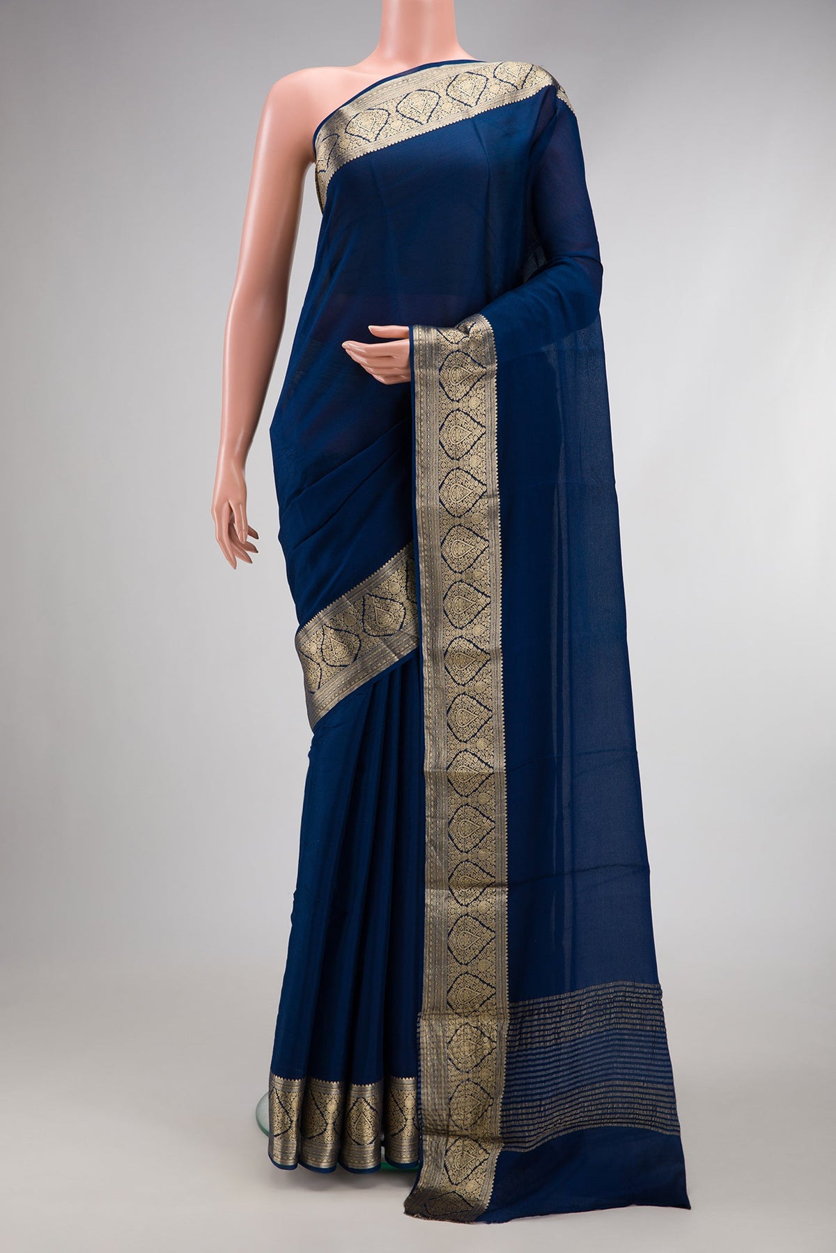 Blue Georgette Saree with Plain Body and Zari Border.  displayed on a mannequin