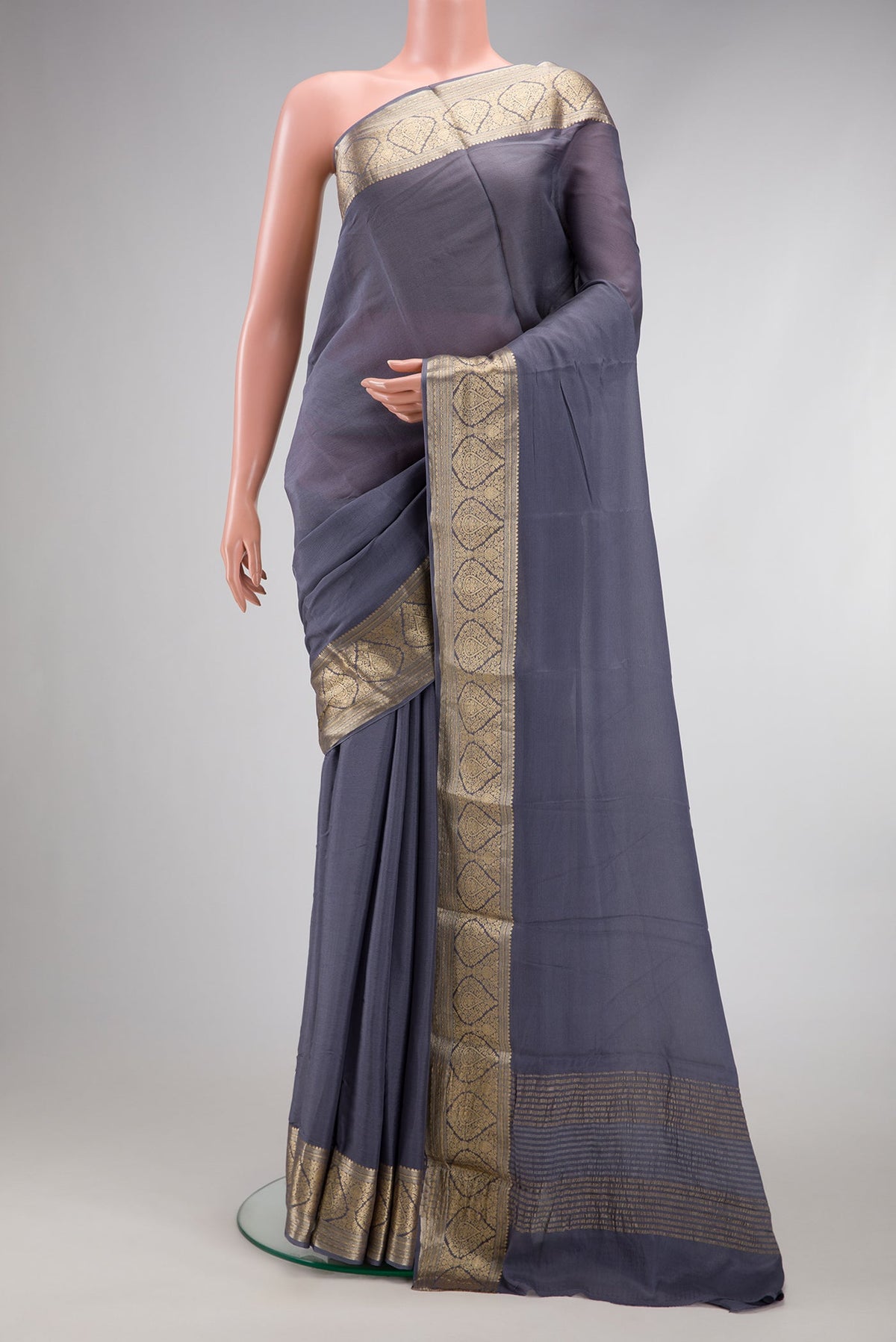 Grey Georgette Saree with Plain Body and Zari Border.  displayed on a mannequin