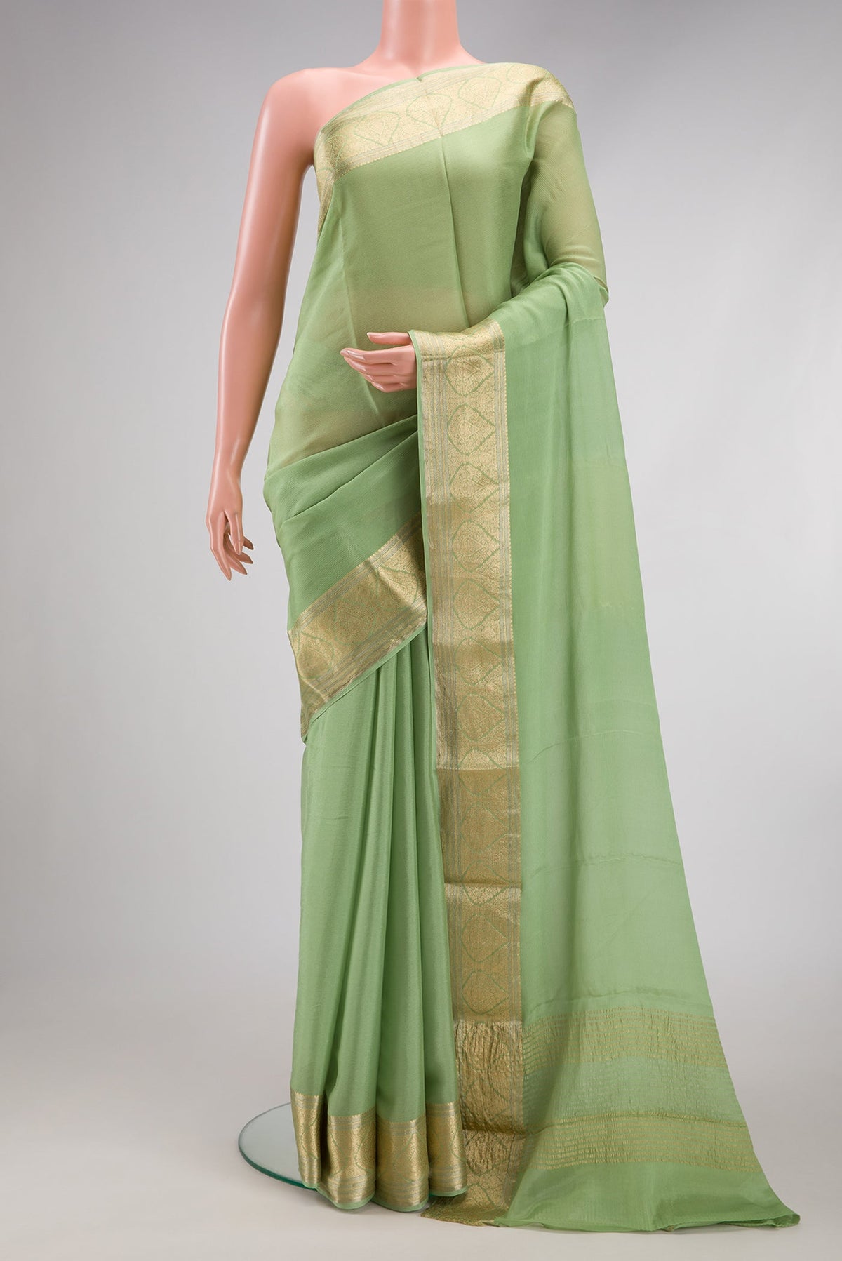 Pista Green Mysore Chiffon Saree with Plain Body and Zari Border.  displayed on a mannequin