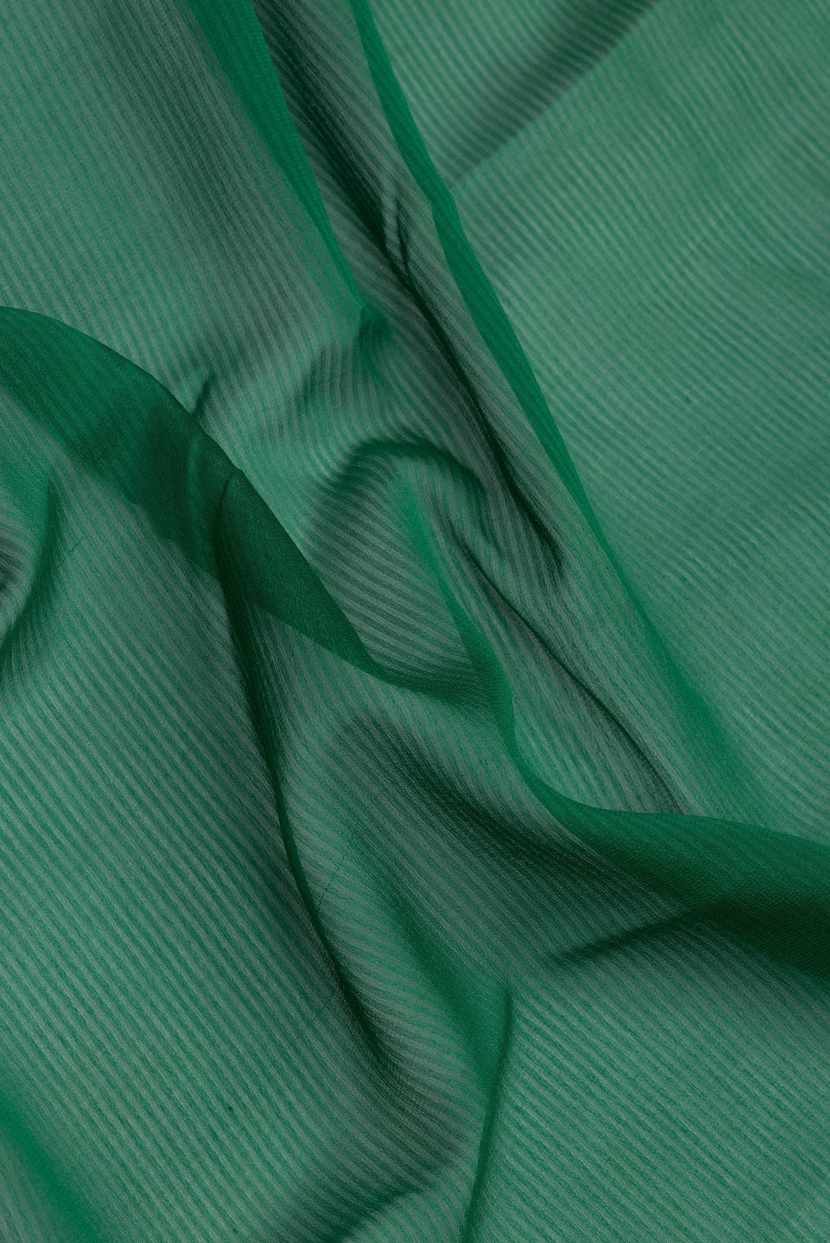 Close up of Green Georgette Saree with Stripes on the body and Zari Border.  displaying folds