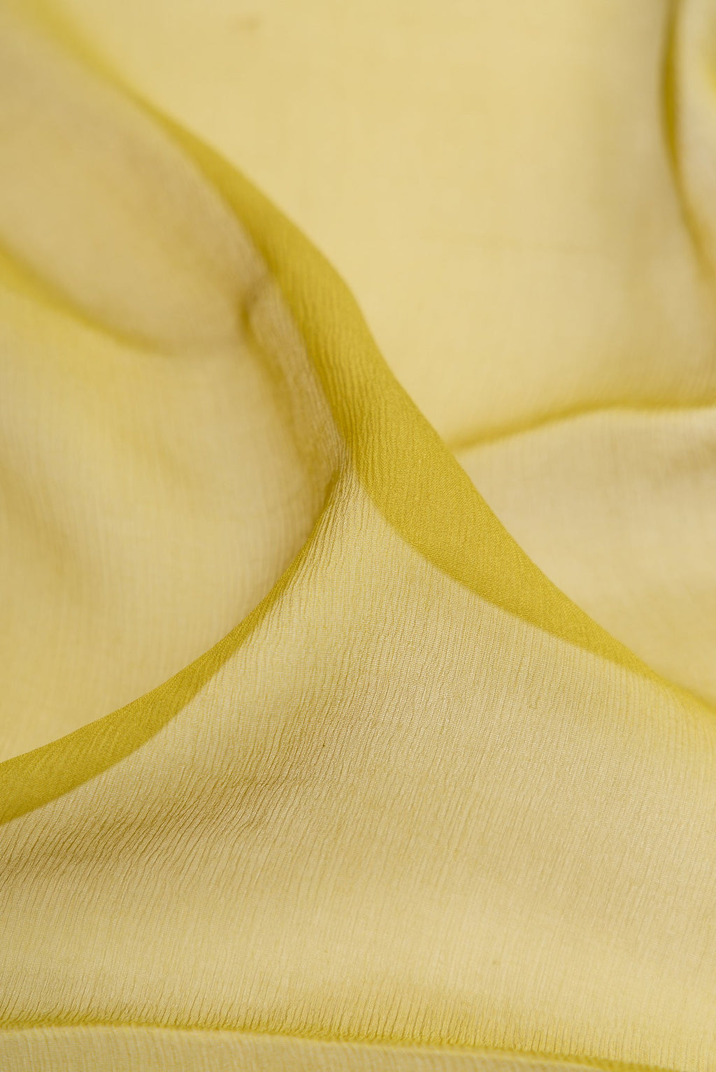 Close up of Mehandi Green Mysore Chiffon Saree with Plain Body and Zari Border.  displaying folds