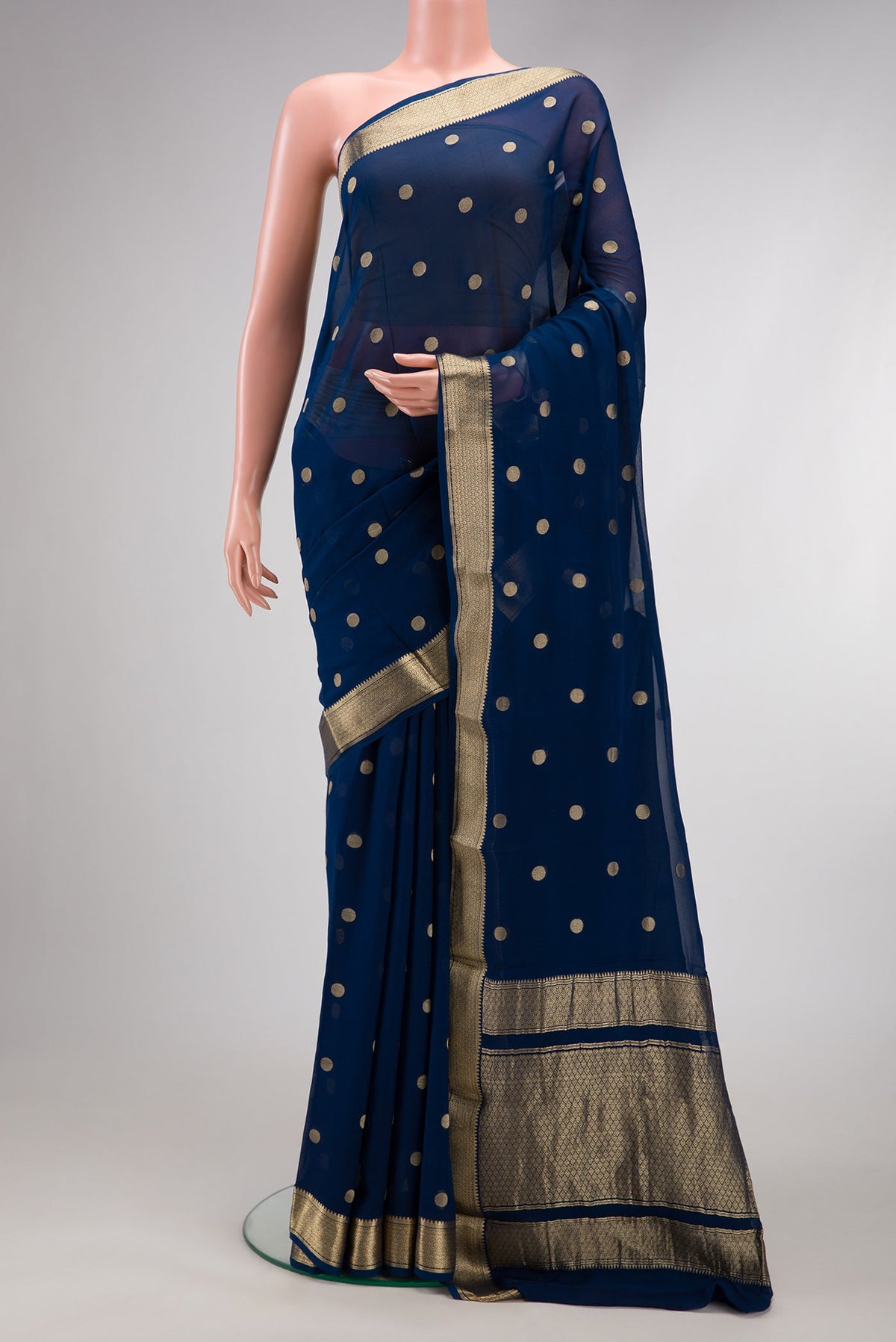 Navy Blue Mysore Georgette Saree with Zari Butta on the body and Zari Border.  displayed on a mannequin