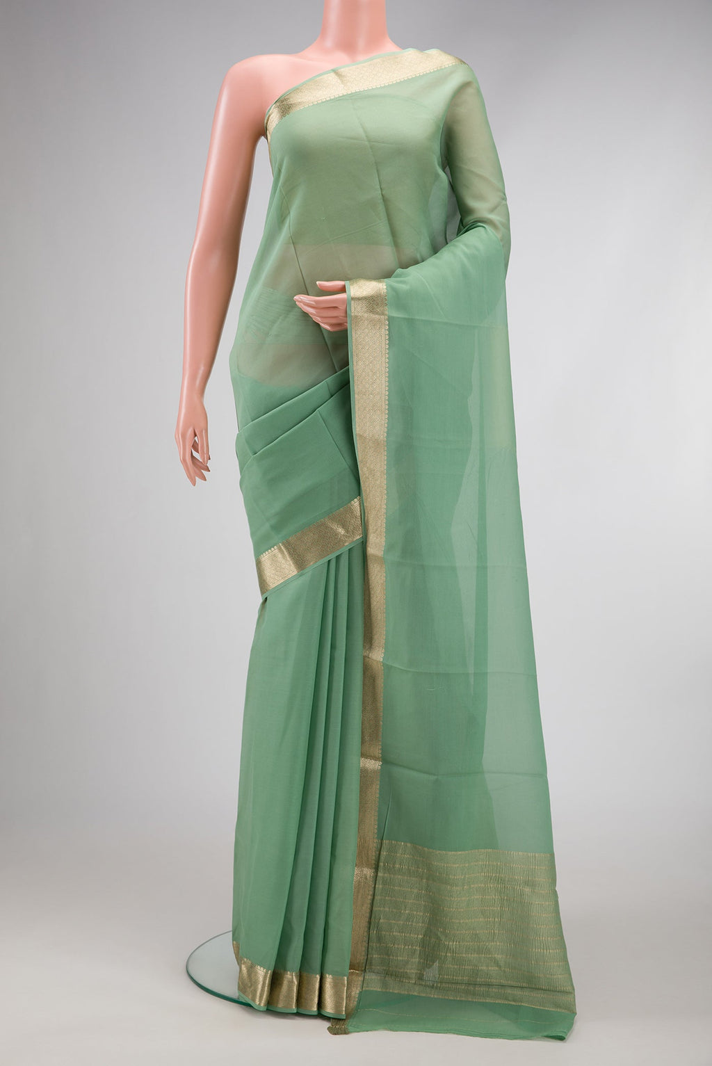Light Green Dual Tone Georgette Saree with Plain Body and Zari Border.  displayed on a mannequin