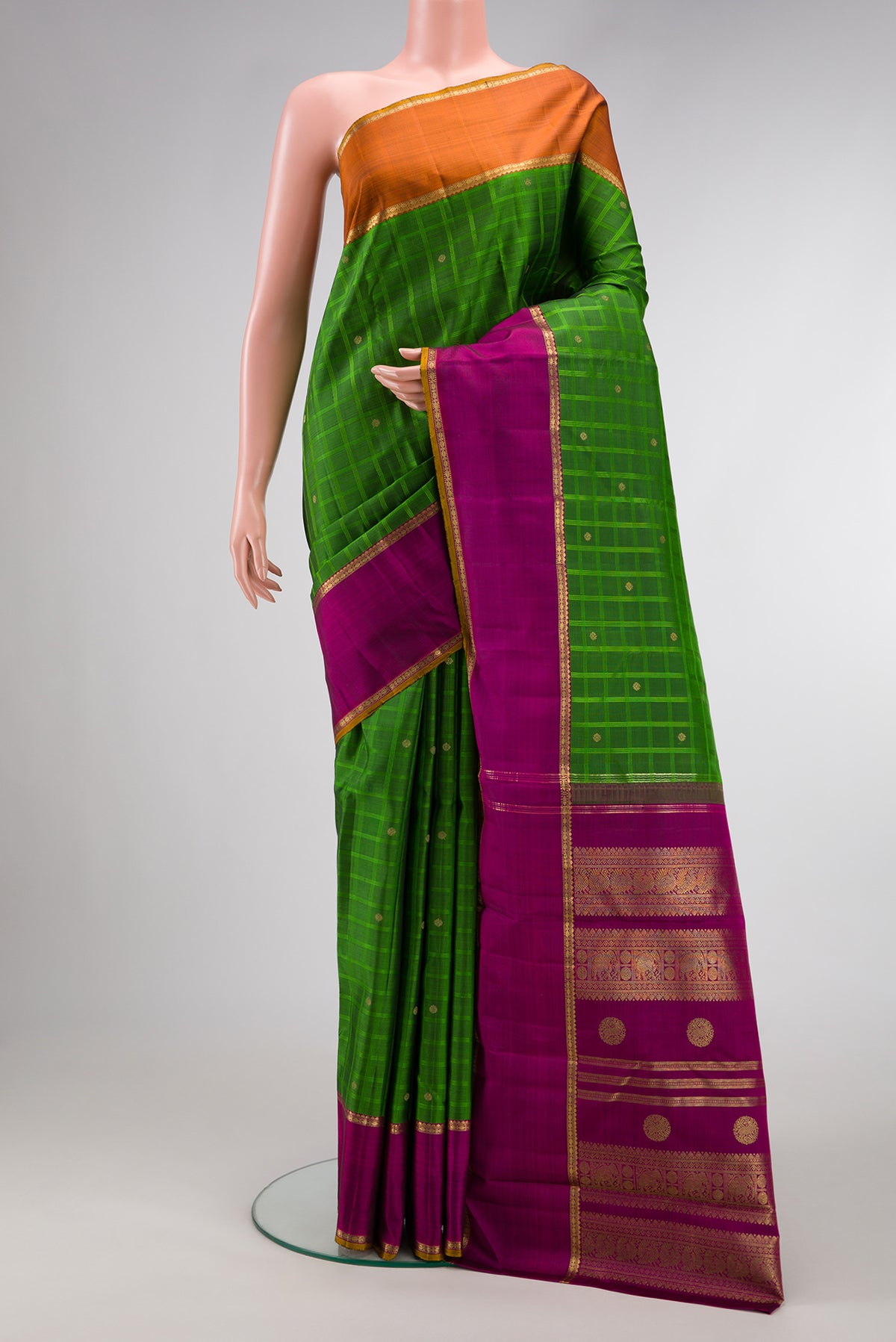 Pure Silk Pure Zari Green Kanchipuram Saree with Checked design on the body and Ganga Jamuna Border.  displayed on a mannequin