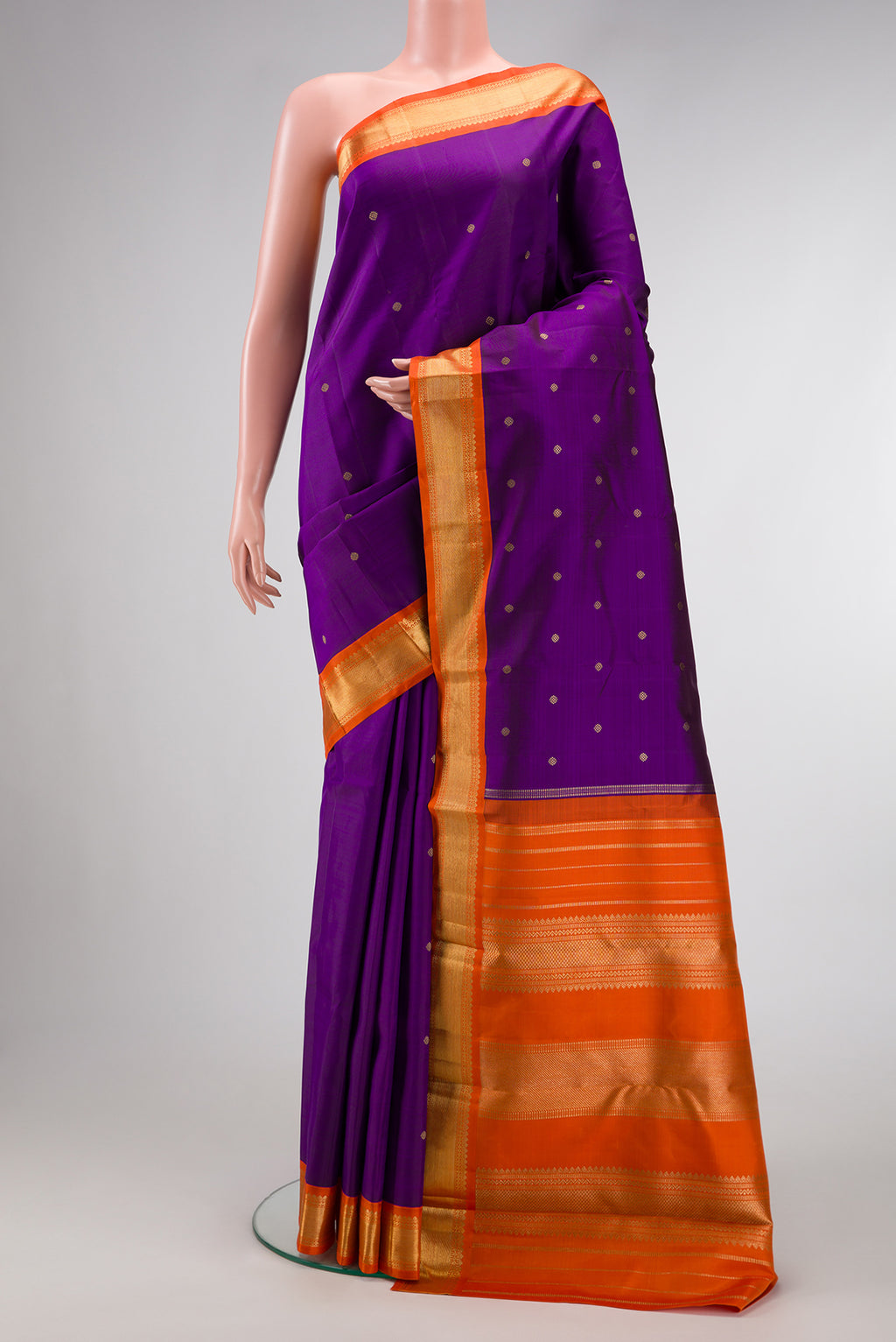 Pure Silk Pure Zari Violet Kanjivaram Saree with Zari Butta on the body and Zari Border.  displayed on a mannequin