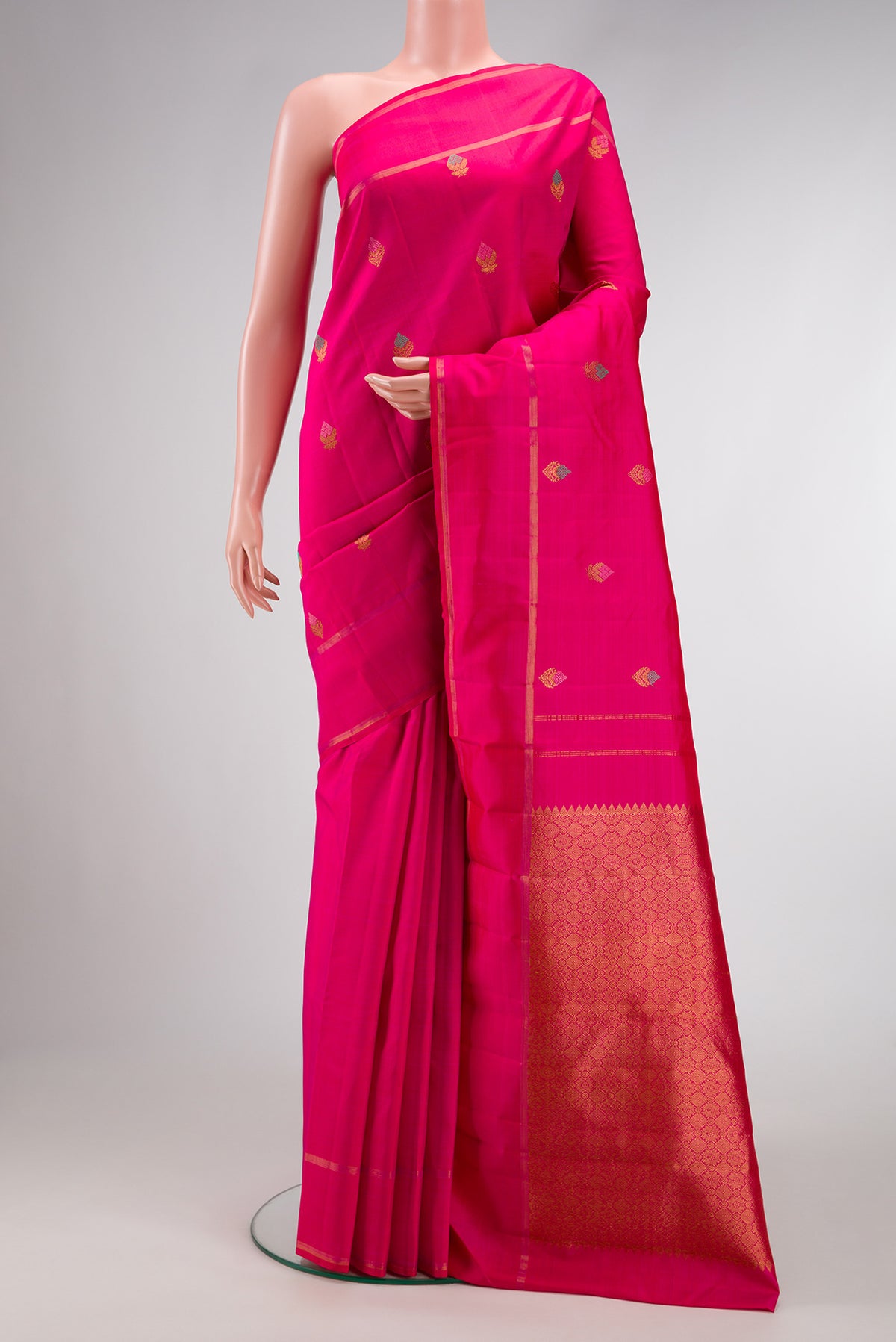 Pure Silk Pure Zari Pink Kanjivaram Saree with Zari And Thread Butta on the body and Plain Border.  displayed on a mannequin