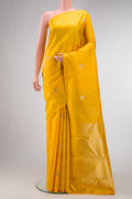 Yellow Kanjivaram Silk Saree with Zari And Thread Butta on the body and Thin Zari Line.  displayed on a mannequin