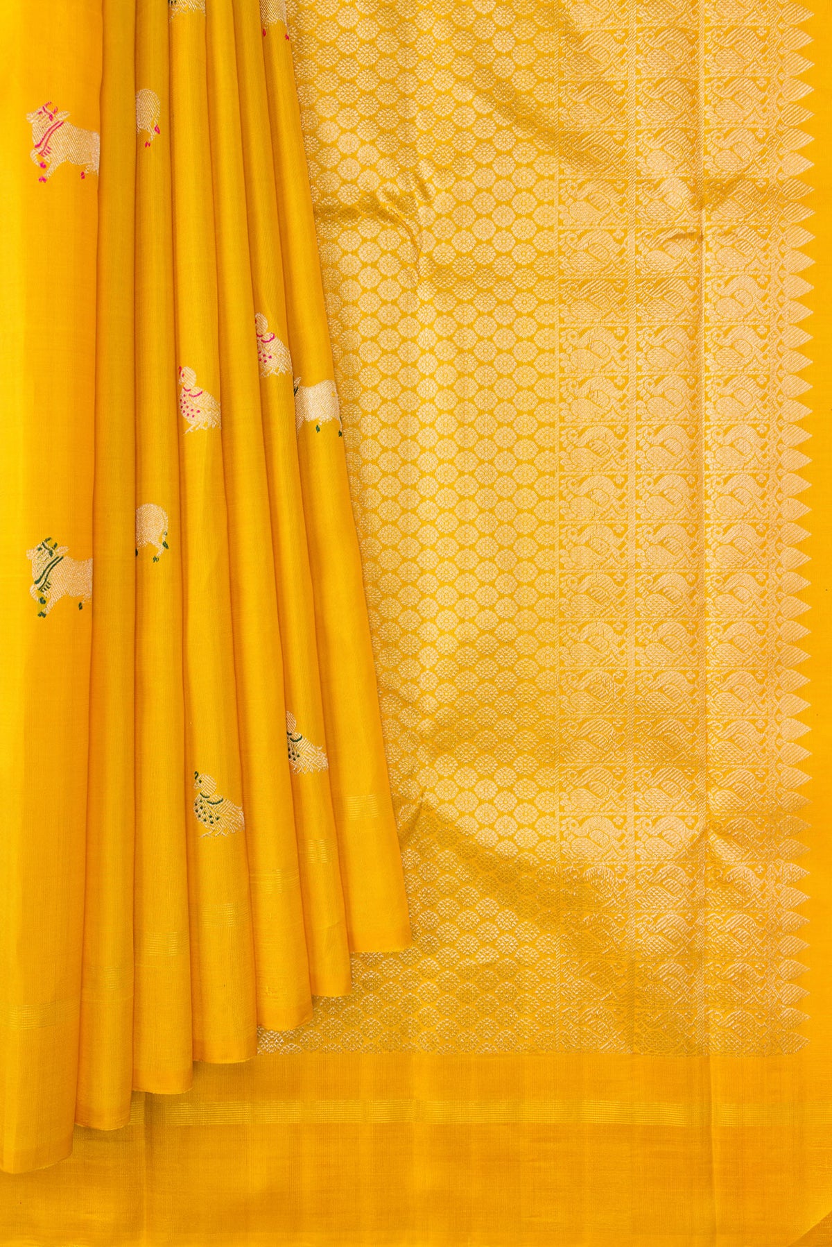 Pleats and pallu of Yellow Kanjivaram Silk Saree with Zari And Thread Butta on the body and Thin Zari Line. 