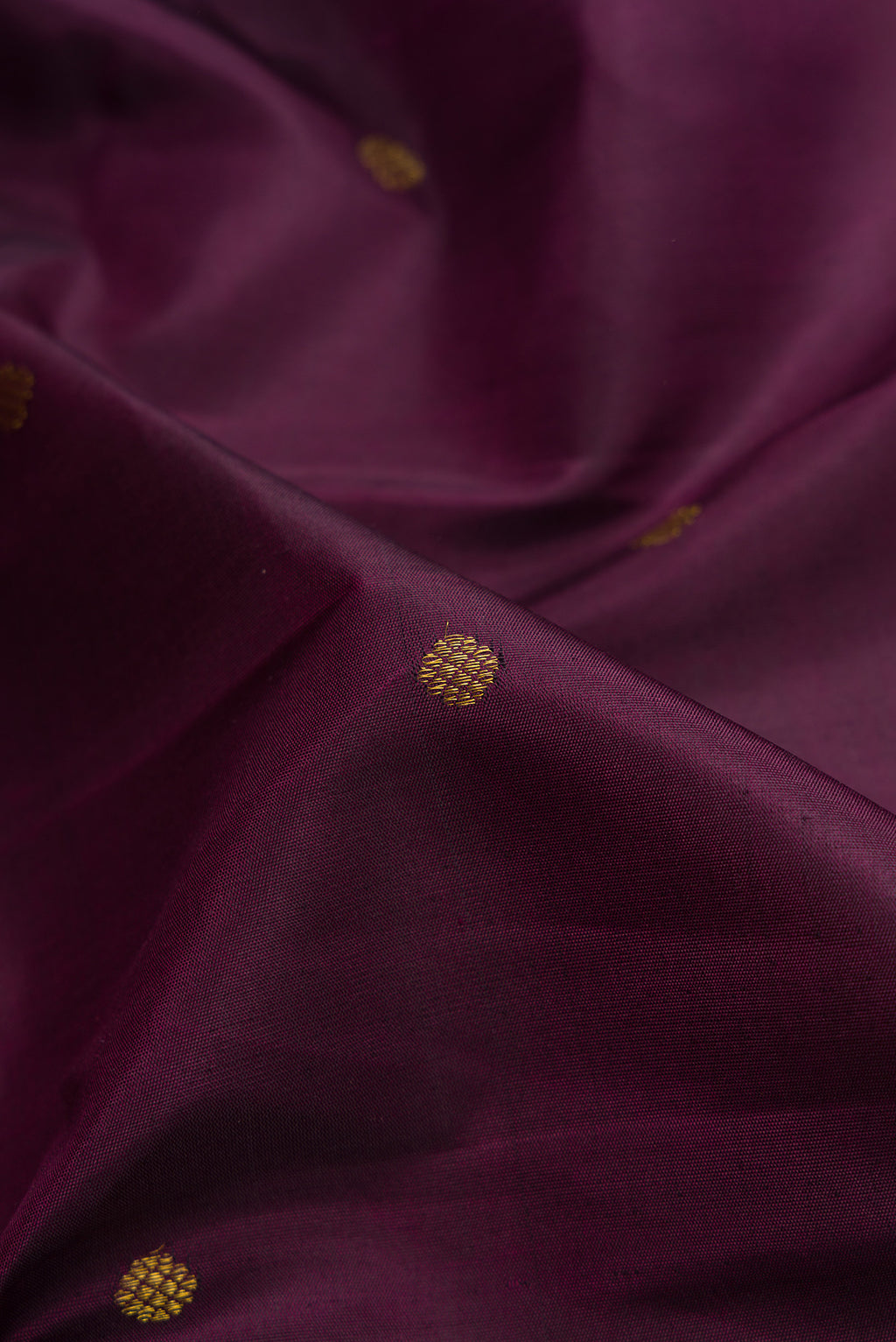 Close up of Purple Kanchipuram Silk Saree with Zari Butta on the body and Fancy Border.  displaying folds