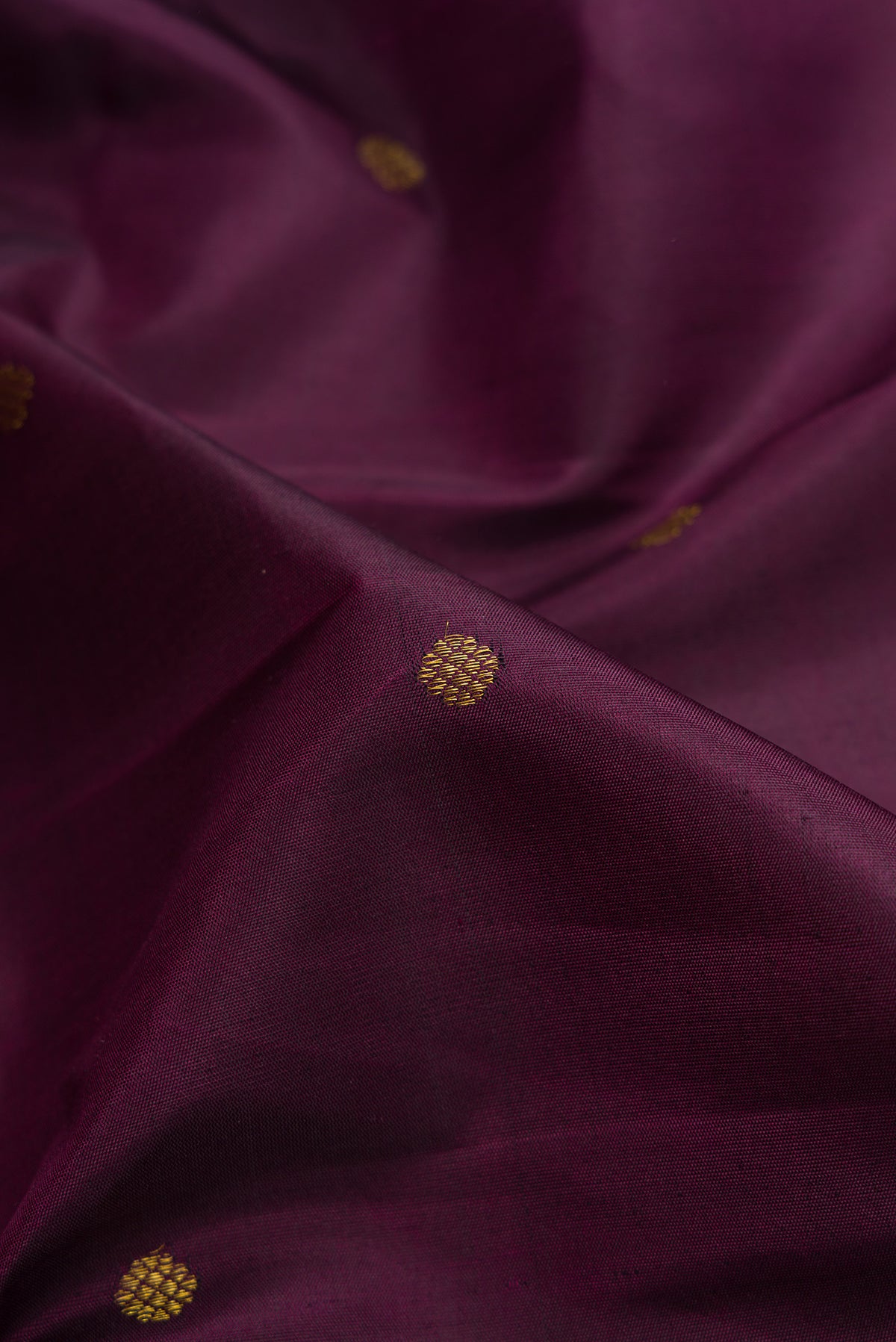Close up of Purple Kanchipuram Silk Saree with Zari Butta on the body and Fancy Border.  displaying folds
