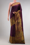 Purple Kanchipuram Silk Saree with Zari Butta on the body and Fancy Border.  displayed on a mannequin