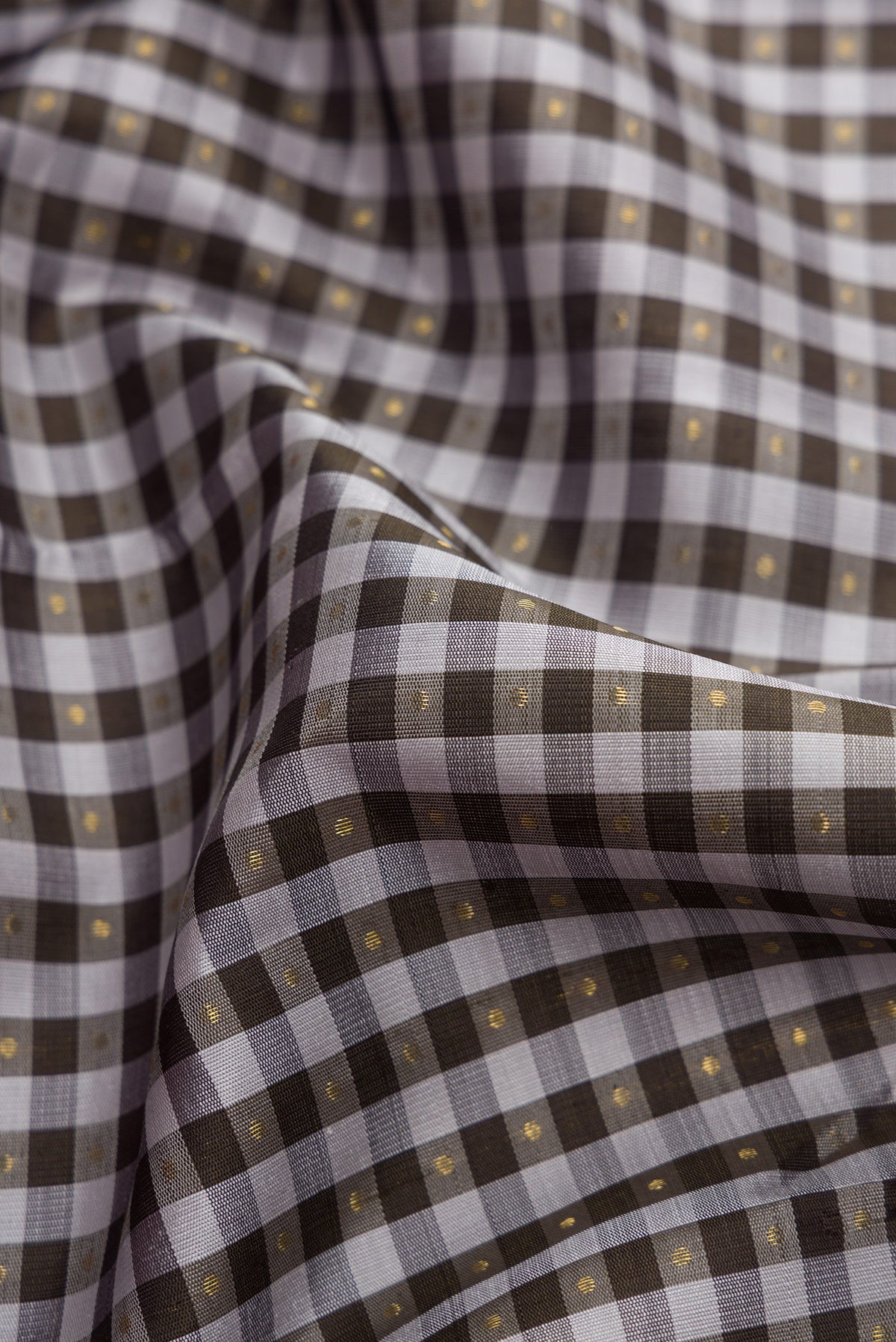 Close up of Pure Silk Pure Zari Grey Kanjivaram Saree with Checked design on the body and Zari Border.  displaying folds