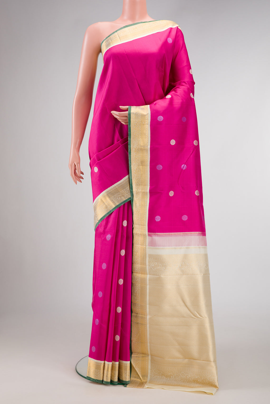 Pink Kanjivaram Silk Saree with Thread Butta on the body and Zari Border.  displayed on a mannequin