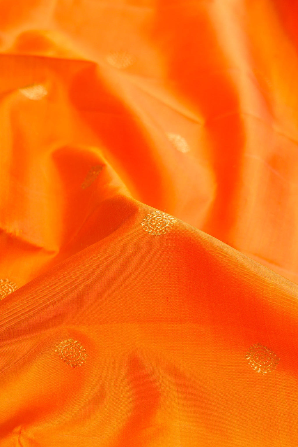 Close up of Mustard Dual Tone Kanjivaram Silk Saree with Zari Butta on the body and Zari Border.  displaying folds