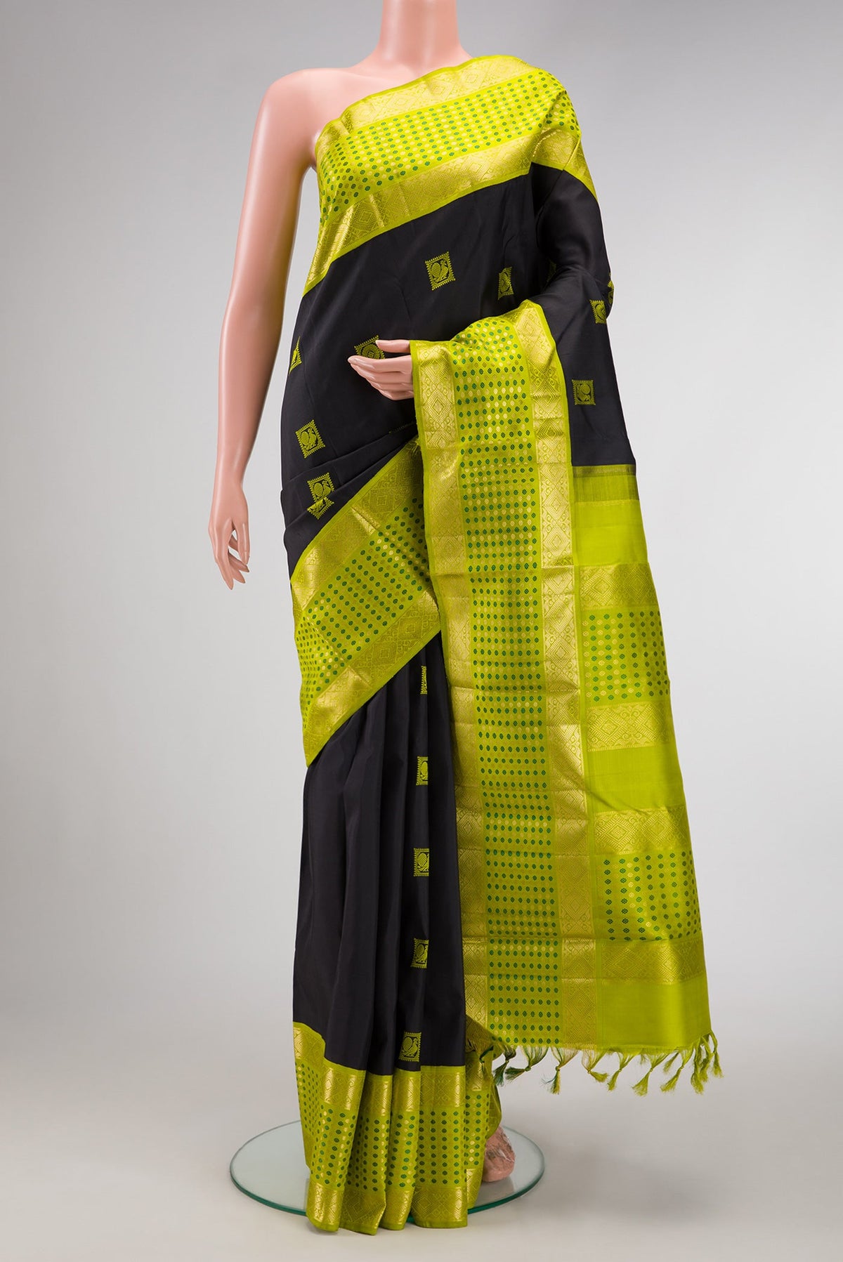 Black Dual Tone Kanjivaram Silk Saree with Thread Butta on the body and Fancy Border.  displayed on a mannequin