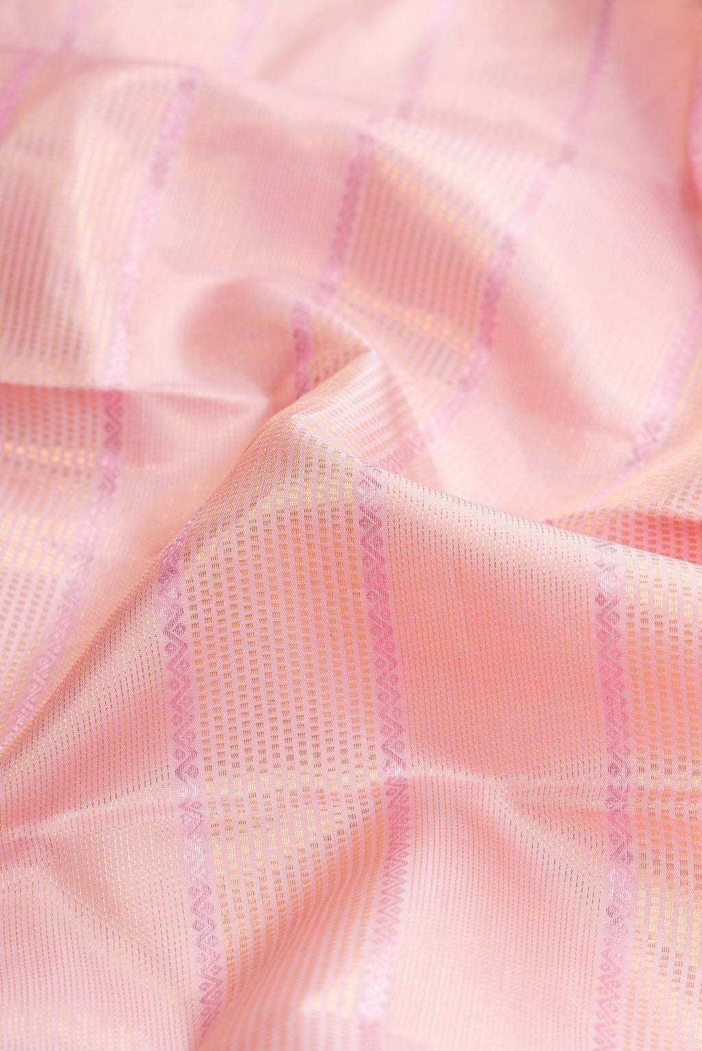 Close up of Pink Dual Tone Kanchipuram Silk Saree with Checked design on the body and Zari Border.  displaying folds