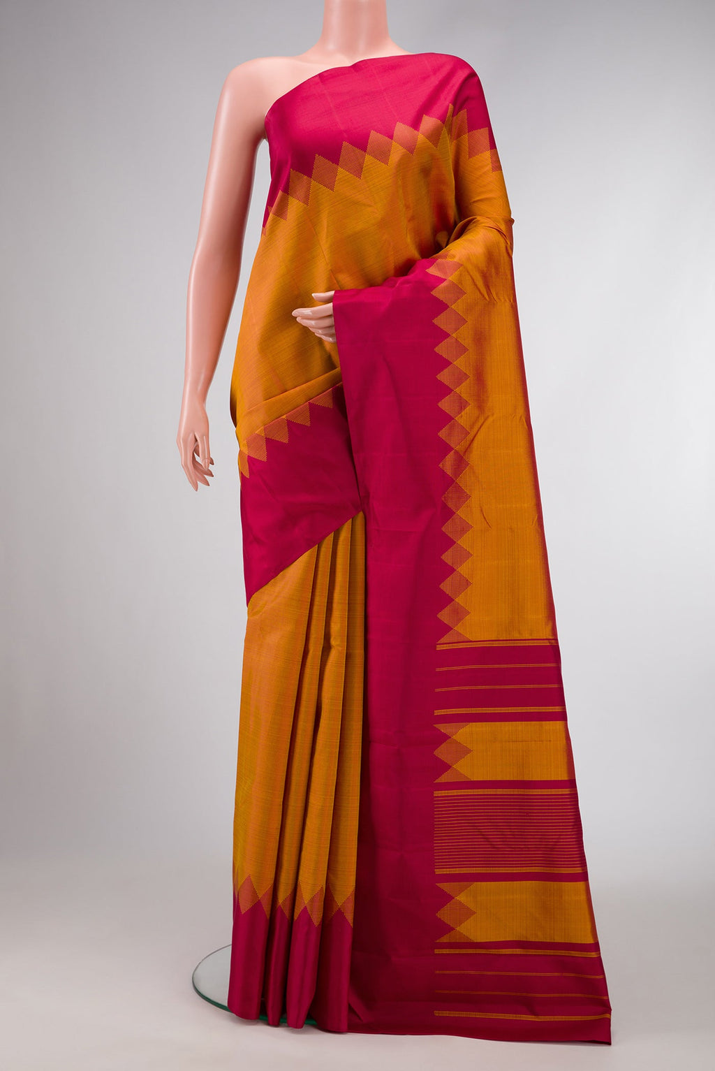 Mustard Dual Tone Kanjivaram Silk Saree with Plain Body and Fancy Border.  displayed on a mannequin