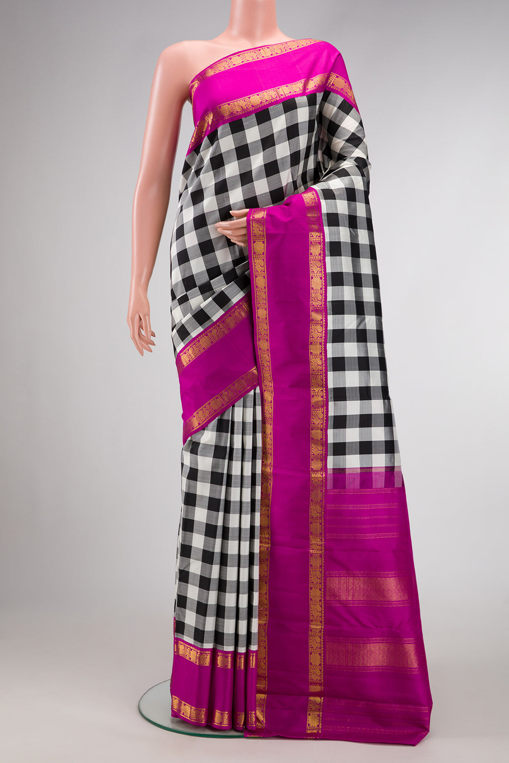 White and Black Color Kanjivaram Silk Saree with Checked design on the body and Zari Border.  displayed on a mannequin