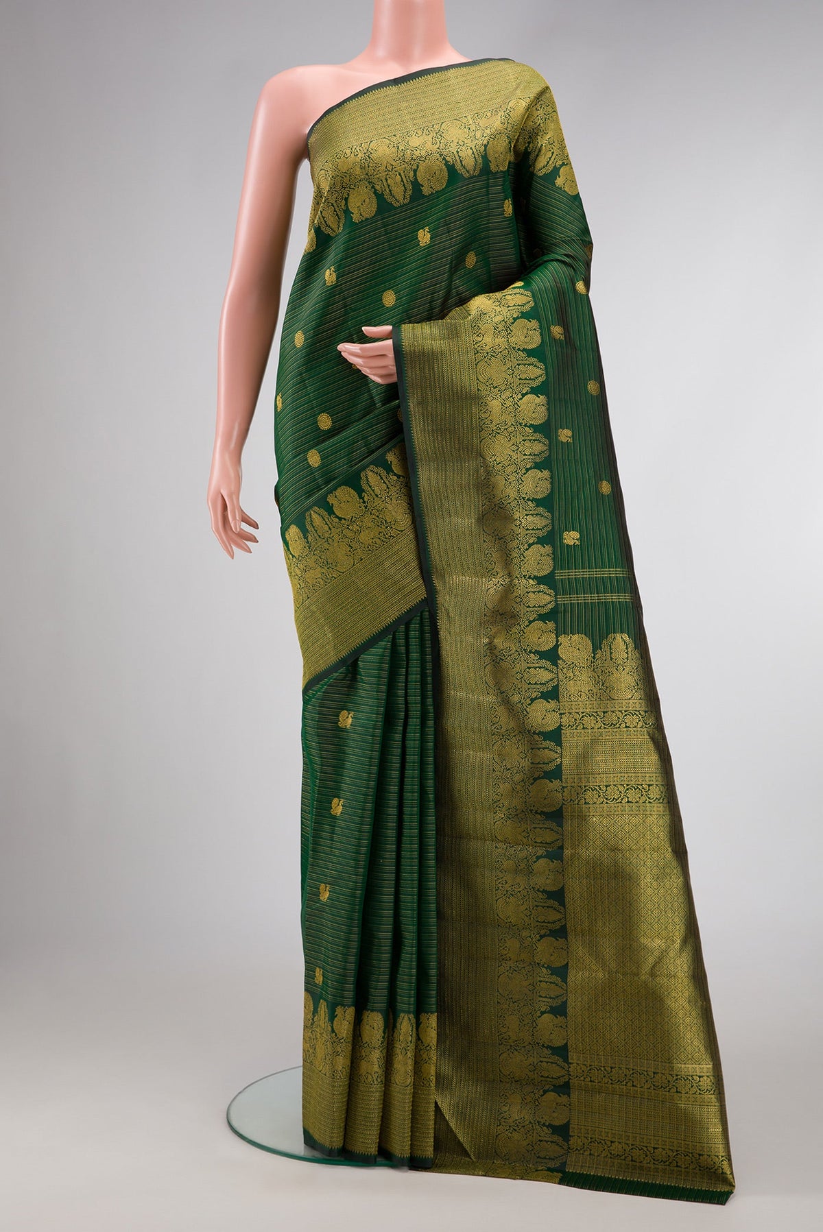 Green Dual Tone Kanchipuram Silk Saree with Zari Butta on the body and Zari Border.  displayed on a mannequin